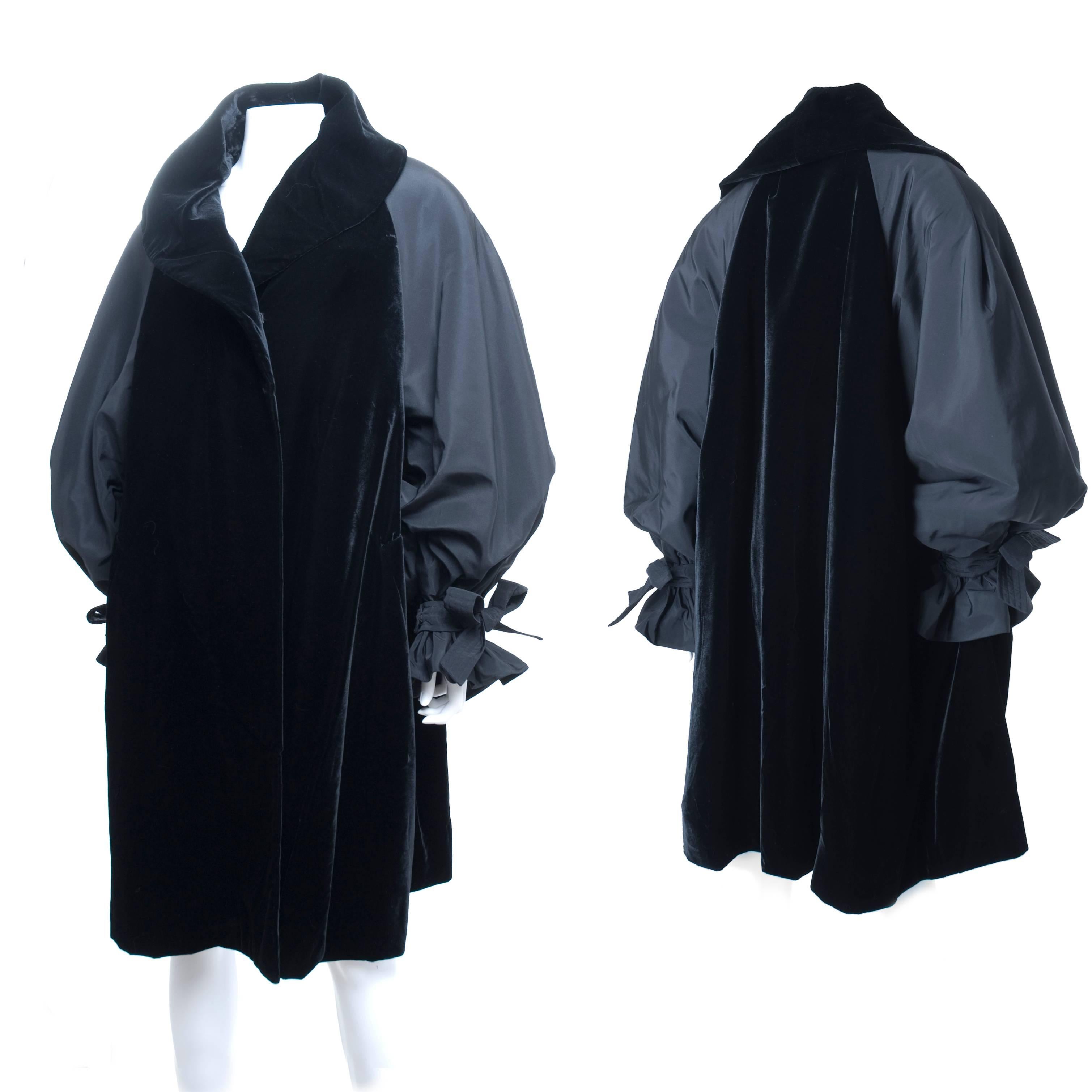 Vintage Christian Lacroix black velvet combined with taffeta sleeves. Oversized style coat from fall 1991 collection. Featuring a black velvet shawl collar and sleeves with frilled cuff and attached bow. Four black velvet buttons fastening and one