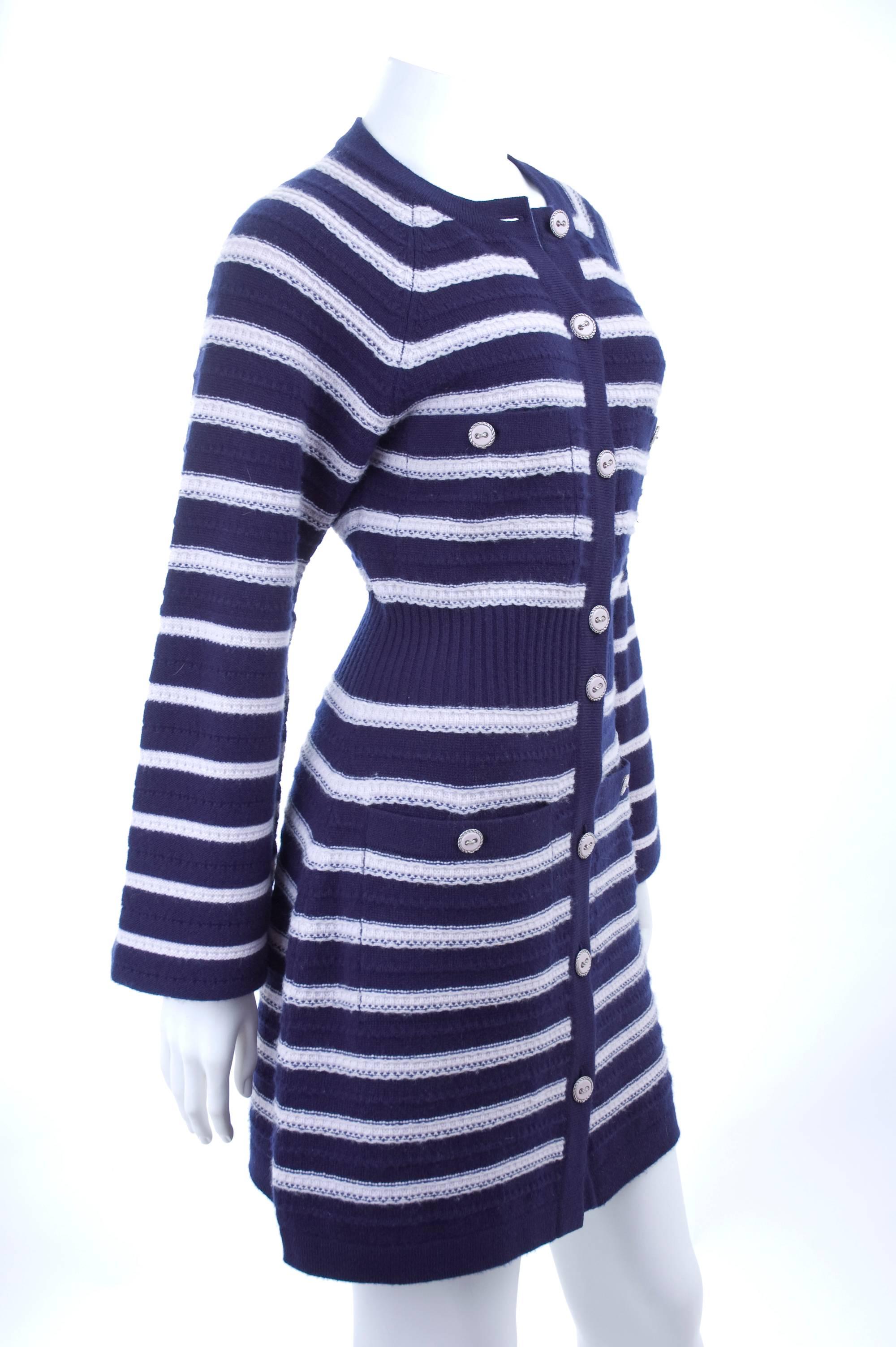 CHANEL cashmere knit jacket in navy with soft pink stripes. 
The buttons have a silver braided outline with a pink center.
The sleeves have the seamline on the outside to elbow high, they probably meant to be rolled up. Show in the pictures both