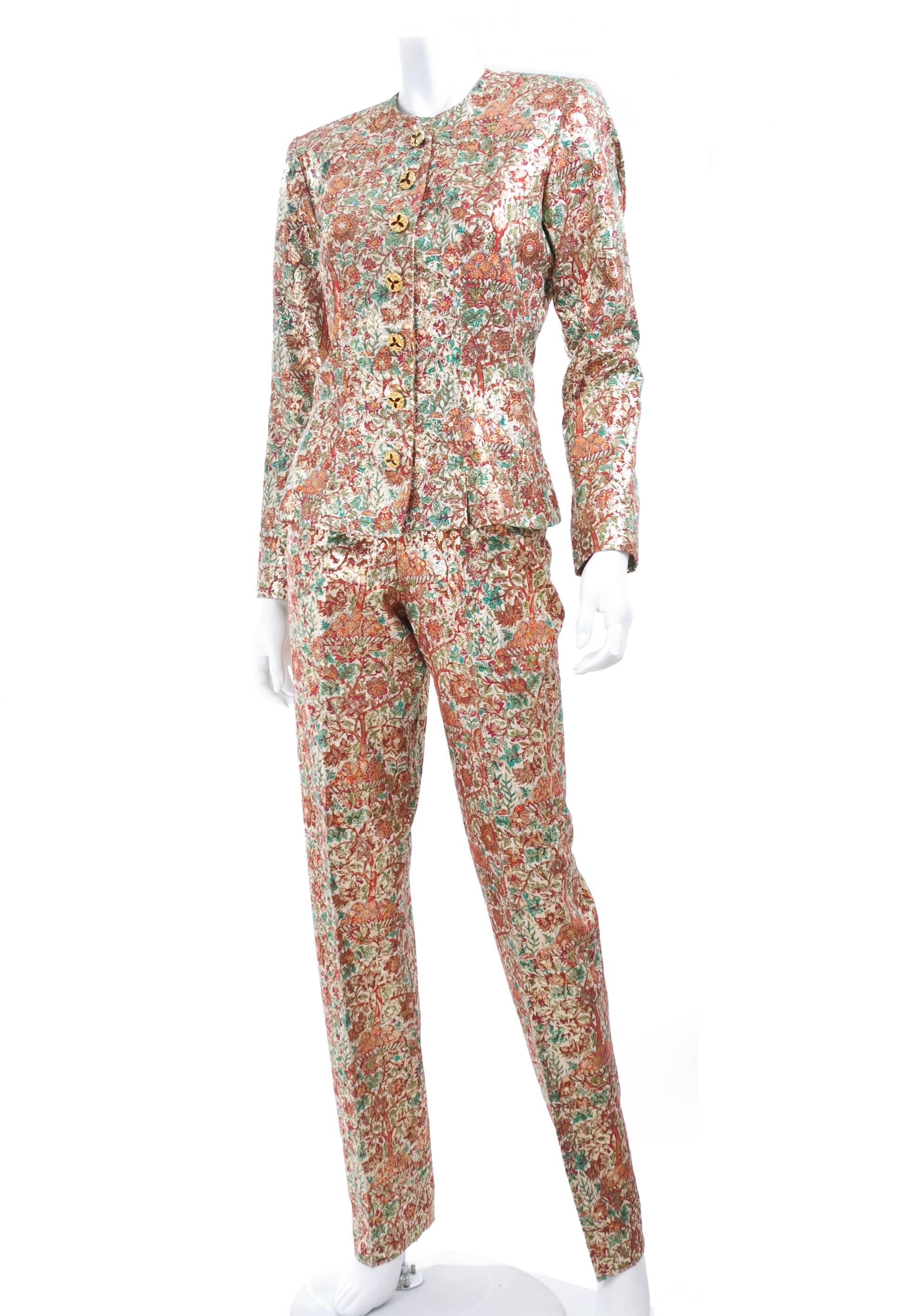 Vintage Yves Saint Laurent gold brocade suit in creme, red and green floral pattern. The Pants are high waisted and have side pockets.
Gilded buttons with red rhinestones.
Excellent condition - looks unworn
Material label is missing, feels like