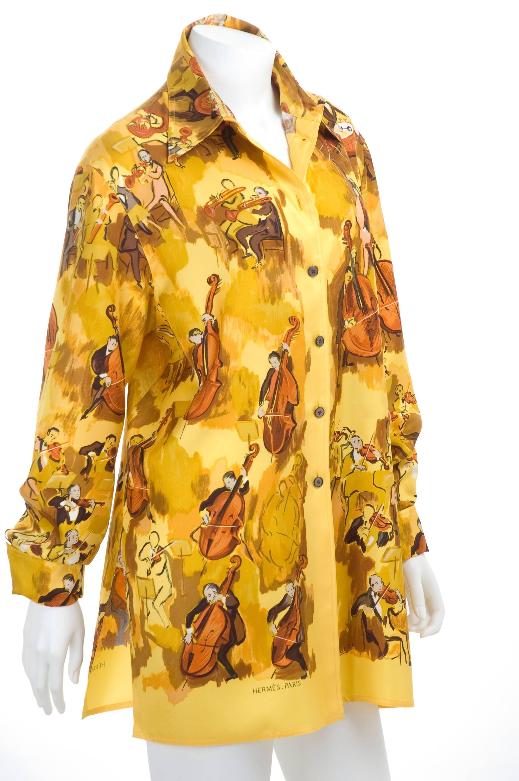 Vintage 90s Hermes silk blouse - CONCERTO - motive design by Clerc. The background color is a golden yellow and the print in brown, grey, oliv and black. In excellent condition - no flaws at all to mention - don't think is was ever worn.
Size 44