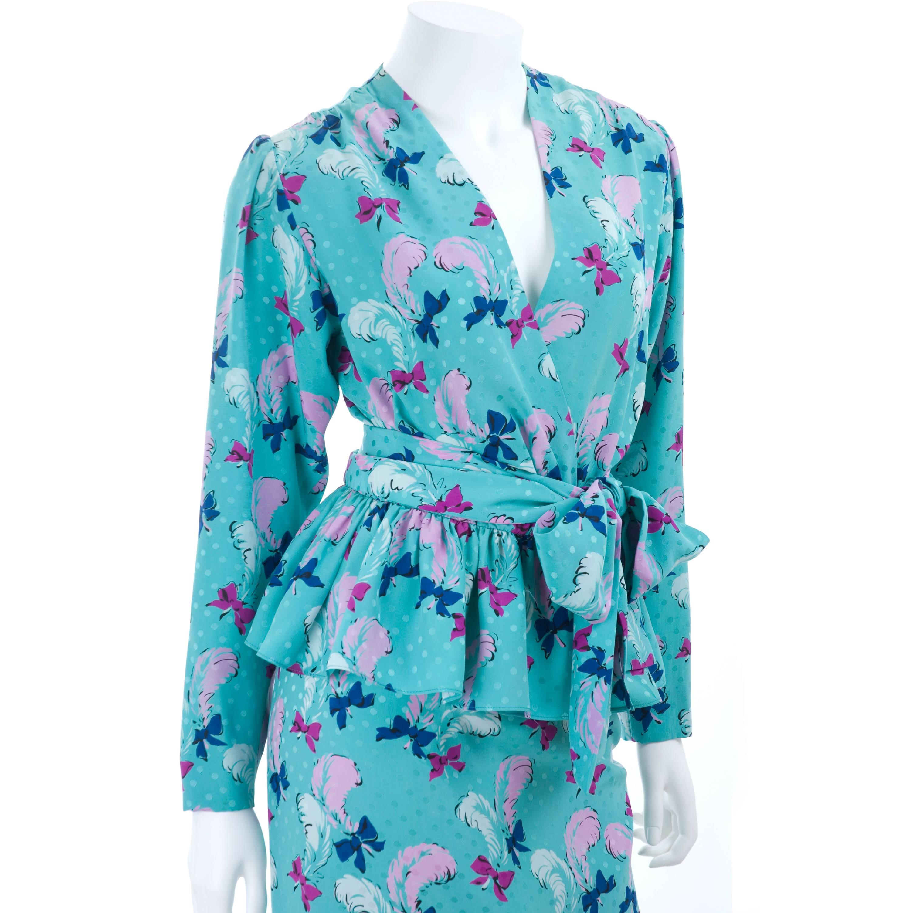 Vintage 1987 Yves Saint Laurent 2 piece silk jacquard dress. Wrap Top with 2 hook closure and attached sash. Turquoise background with white and pink feathers and pink and royal blue bow print.
Size 40 EU 
In excellent condition- no flaws to