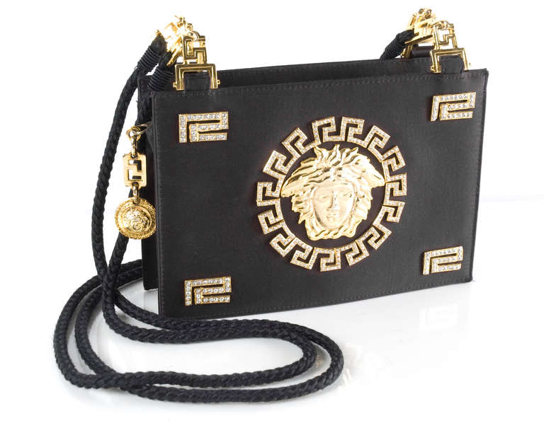 Vintage Gianni Versace Couture Black Satin Evening Purse.
Gold Medusa with Roman Greco in Rhinestones. 
Braided silk shoulder handles.
From the 1992 collection
Excellent Condition

Measurements:
Height 6