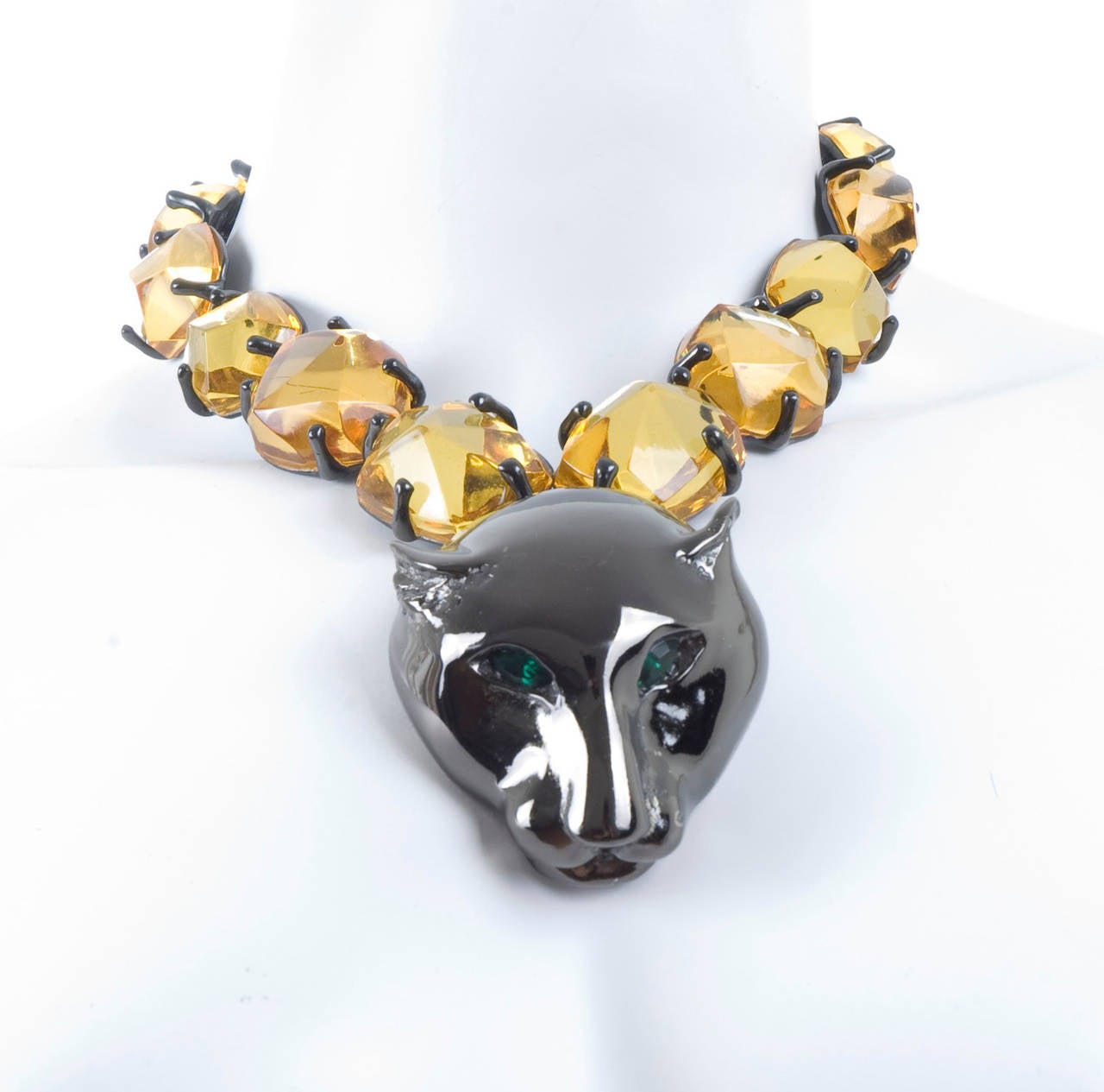 Yves Saint Laurent Necklace and clip-on Earrings.
The large metal Leopard head is 2.5 by 2 inches.
The gold color stones are glass.
In excellent condition