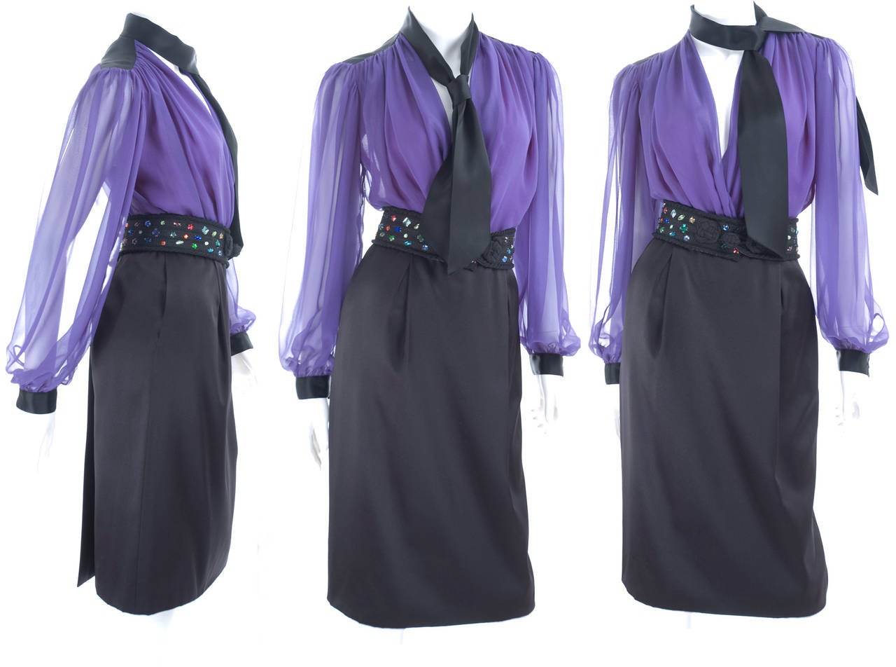 Yves Saint Laurent blouse & skirt & belt ensemble. The silk chiffon wrap blouse with attached tie in black satin. The black satin back wrap skirt with pockets in the side seam.
2.5 inches wide cord belt with colored rhinestones.
Excellent cindition