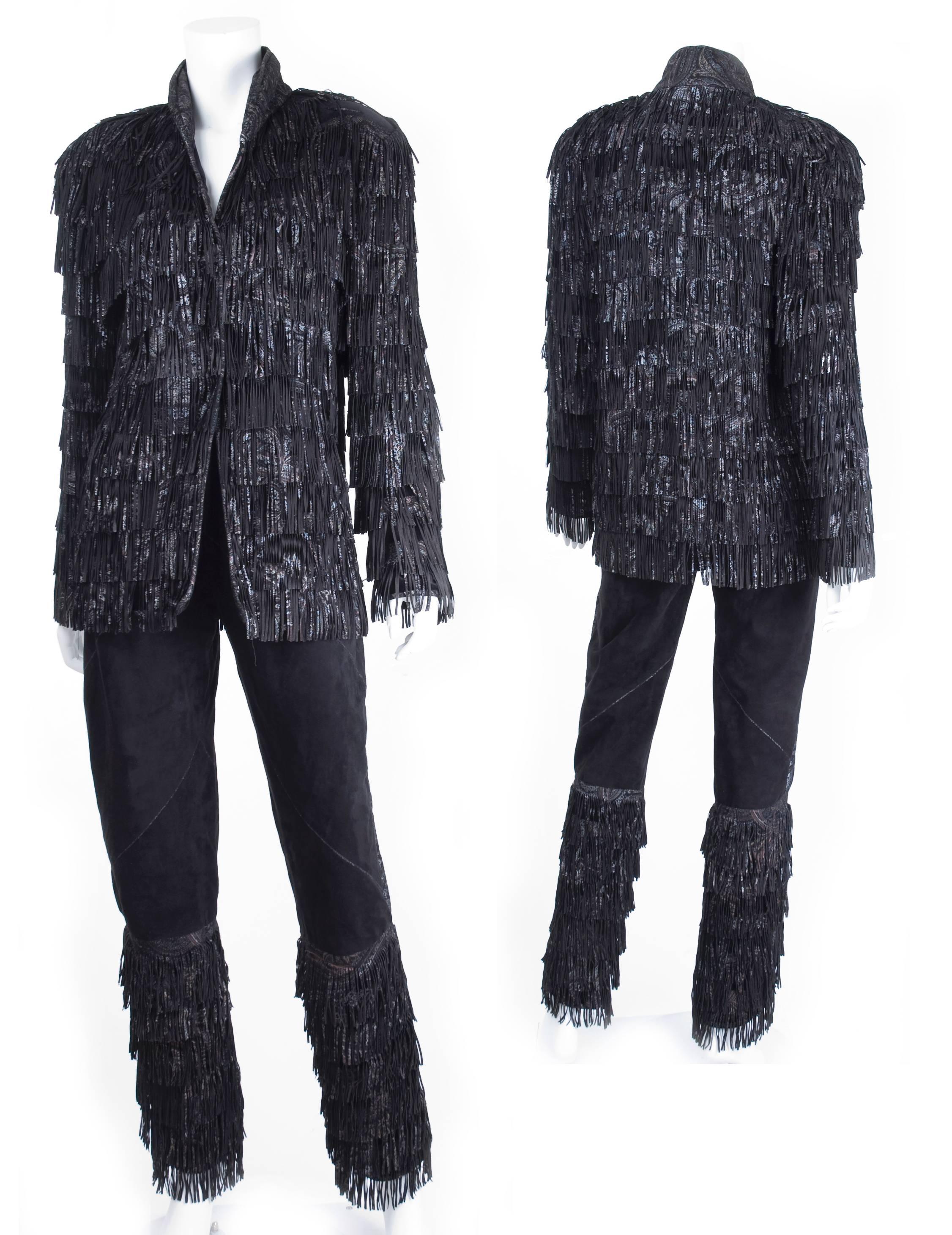 1980s Roberto Cavalli suede suit with fringes. All painted suede fringes are sawn on to a cotton material. The pants are suede leather to knee height and lined.
The Leather is painted in silver, pink and grey.
The suit was once worn to an event