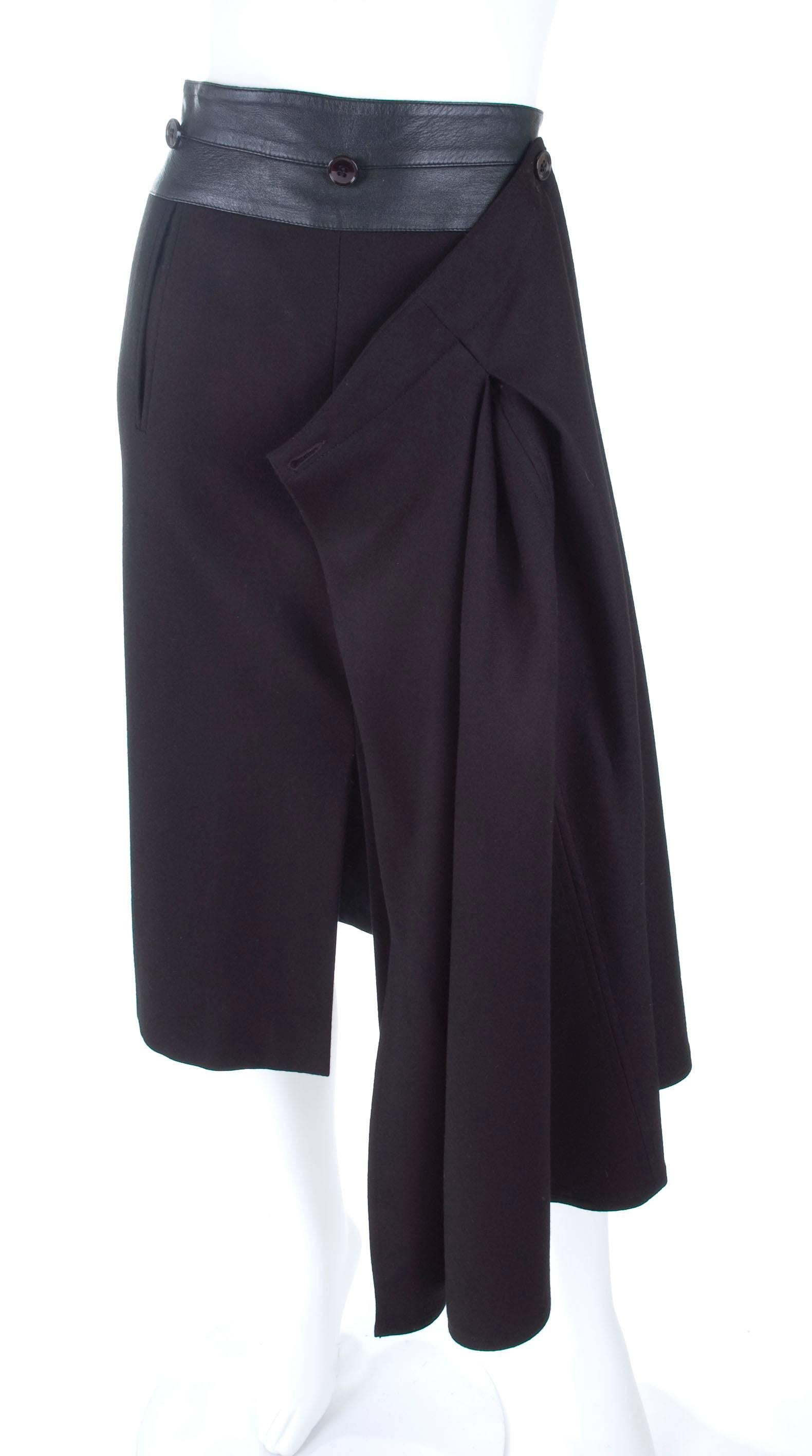 Vintage 1980's Gianfranco Ferre Black Skirt made from wool and leather. 
Pencil skirt with front slit to wear by it's self or with the removable front panel. Excellent condition - no flaws to mention.
Size It 42 - US 6  
Measurements: Length