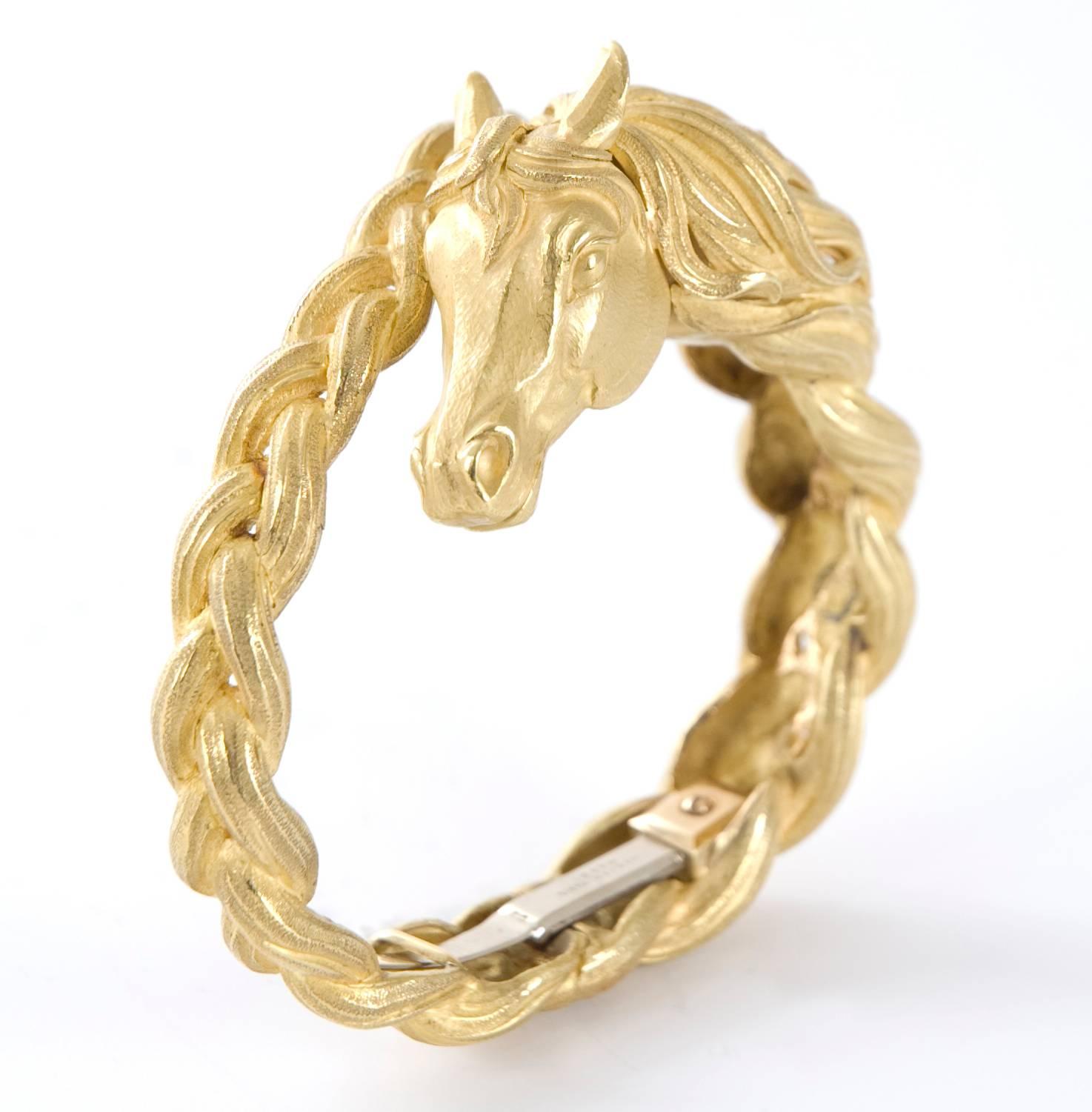 HERMÈS SCULPTED GOLD HORSE BANGLE
Designed as a sculpted gold hinged bangle depicting a horse head and mane
Metal: 18k yellow gold
Size/Dimensions: 15.2 cm, 2 cm at widest point
Signature: HERMÈS
Marks: French gold mark, numbered
Gross Weight: 130.7