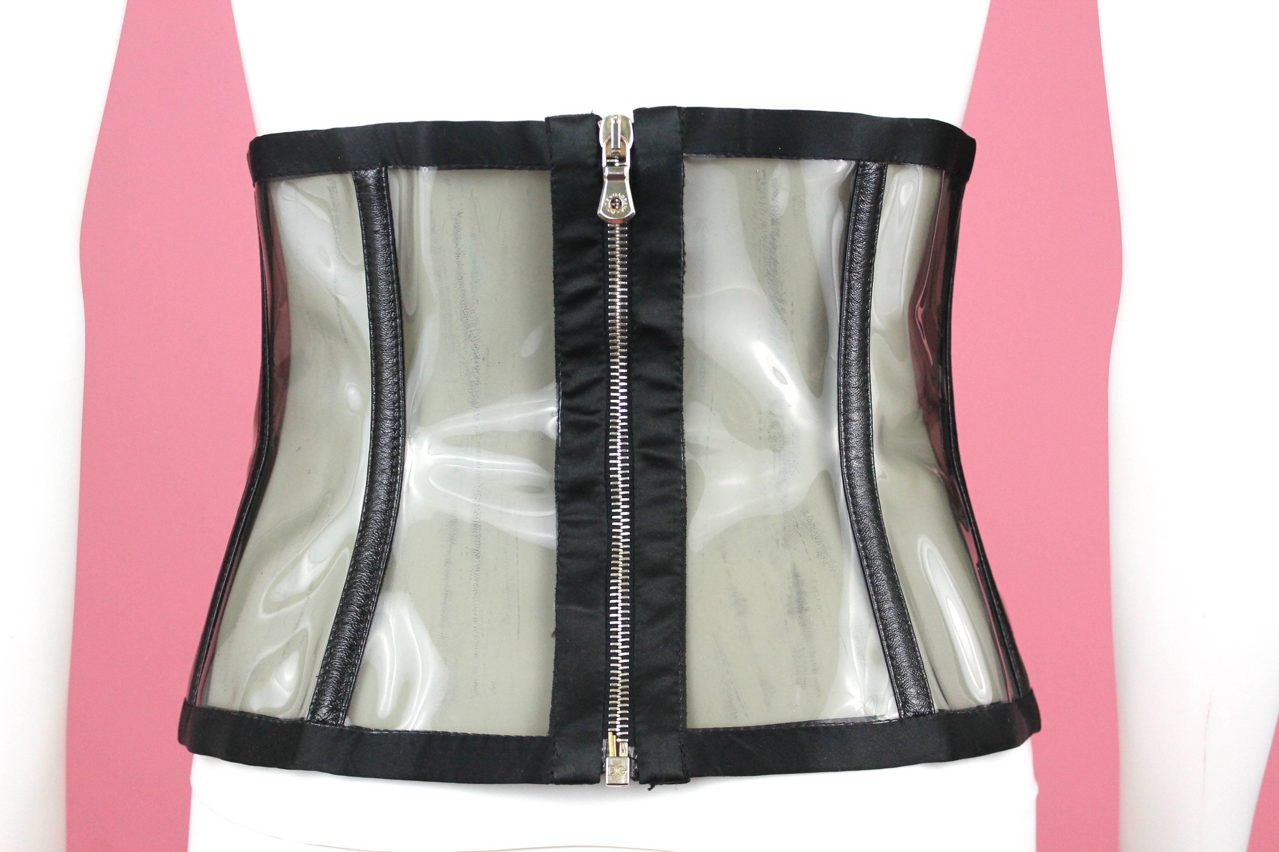 -Waist cincher from Italian label Dolce & Gabbana, sen on the Spring Summer 2007 runway shoe 
-Incredibly versatile piece made from leather, silk, and PVC. Has 8 buckles in gold hardware that are adjustable 
-Boning is encased in silk.
-Made in