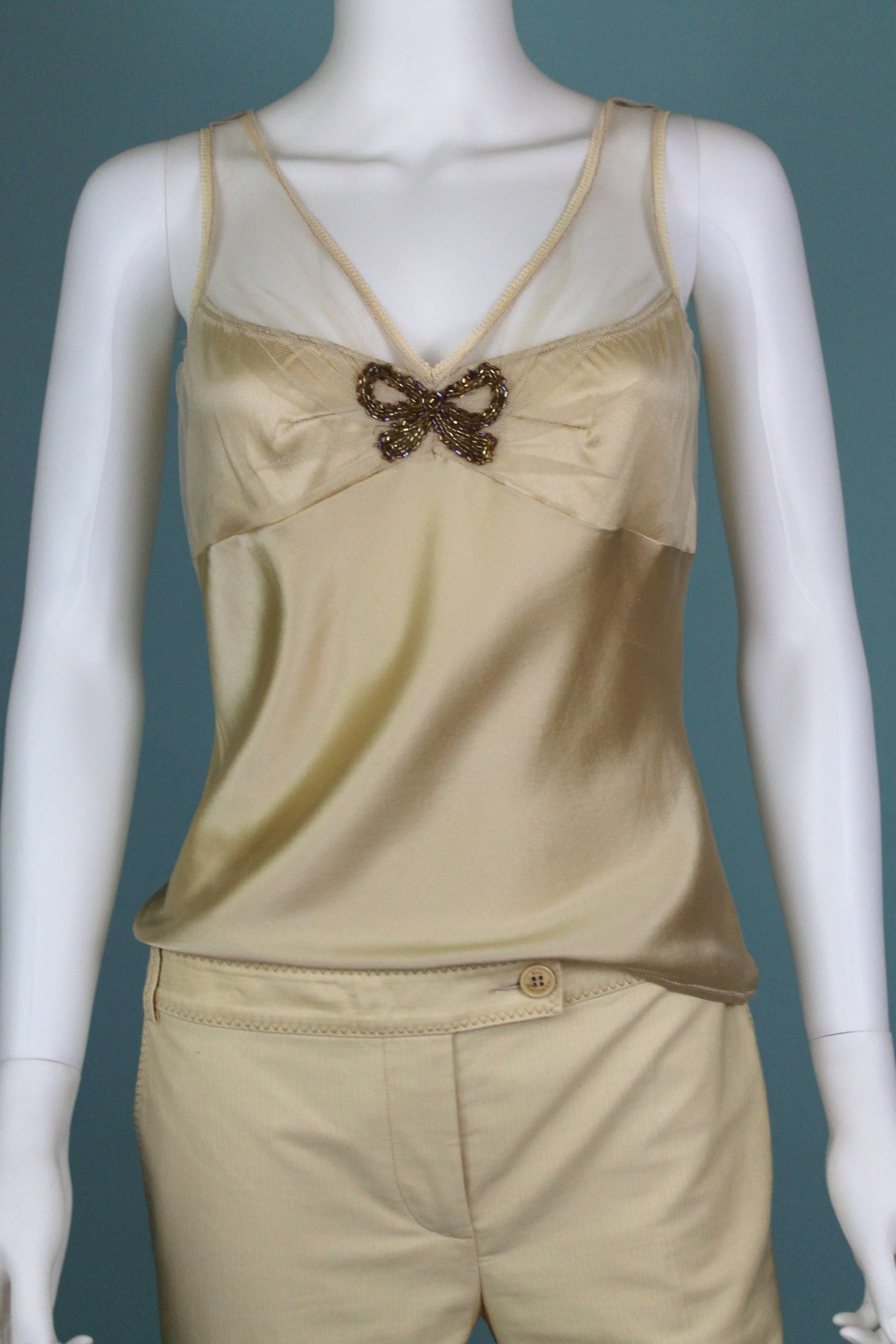 -Beautiful set from John Galliano
-Camisole  tank top is made from silk with lycra so there is a bit of stretch. The bow embellishment on the bust is made out of glass beads. 
-Camisole is sized M. 
-Capri style pants are made from 100% cotton, low