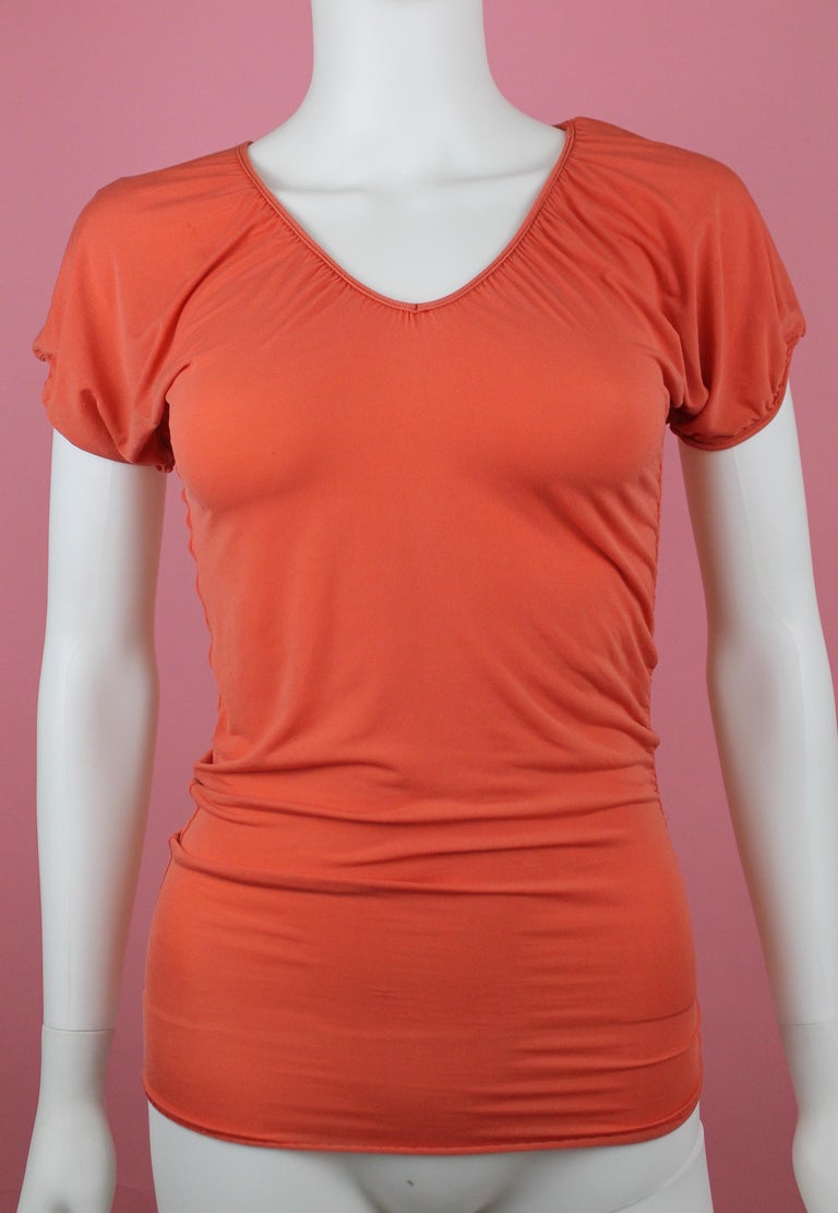 -Orange rayon top from Jean Paul Gaultier Femme
-Has ruched sides and ruched cap sleeves 
-Body con fabric, rayon
-Made in Italy
-Best fitting size 4, has stretch

Approximate Measurements (in inches) 
-Total length: 23