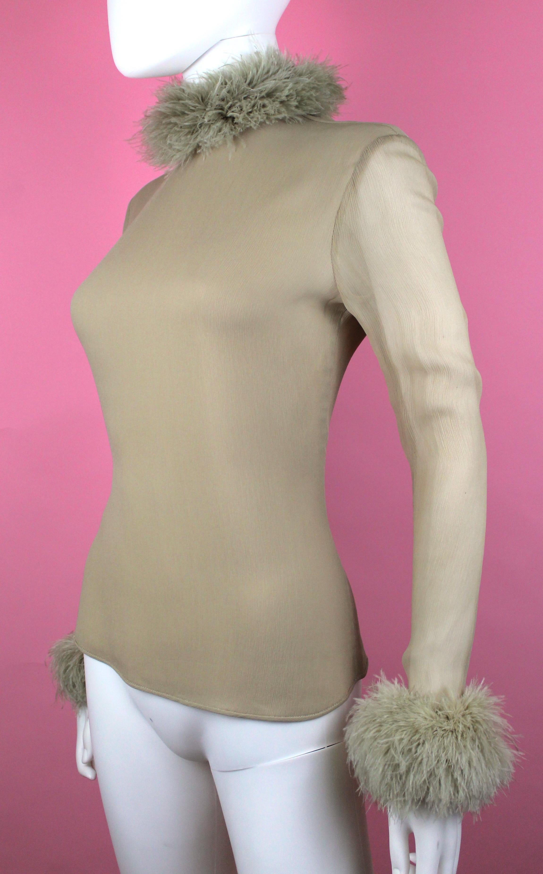 -Valentino Boutique blouse from the 90's
-Made of sheer beige/nude silk and ostrich trim at collar and cuff
-Zips from the back
-Cuffs also zip 
-Please note to carefully and slowly zip up garment as it is very delicate silk fabric
-Made in Italy