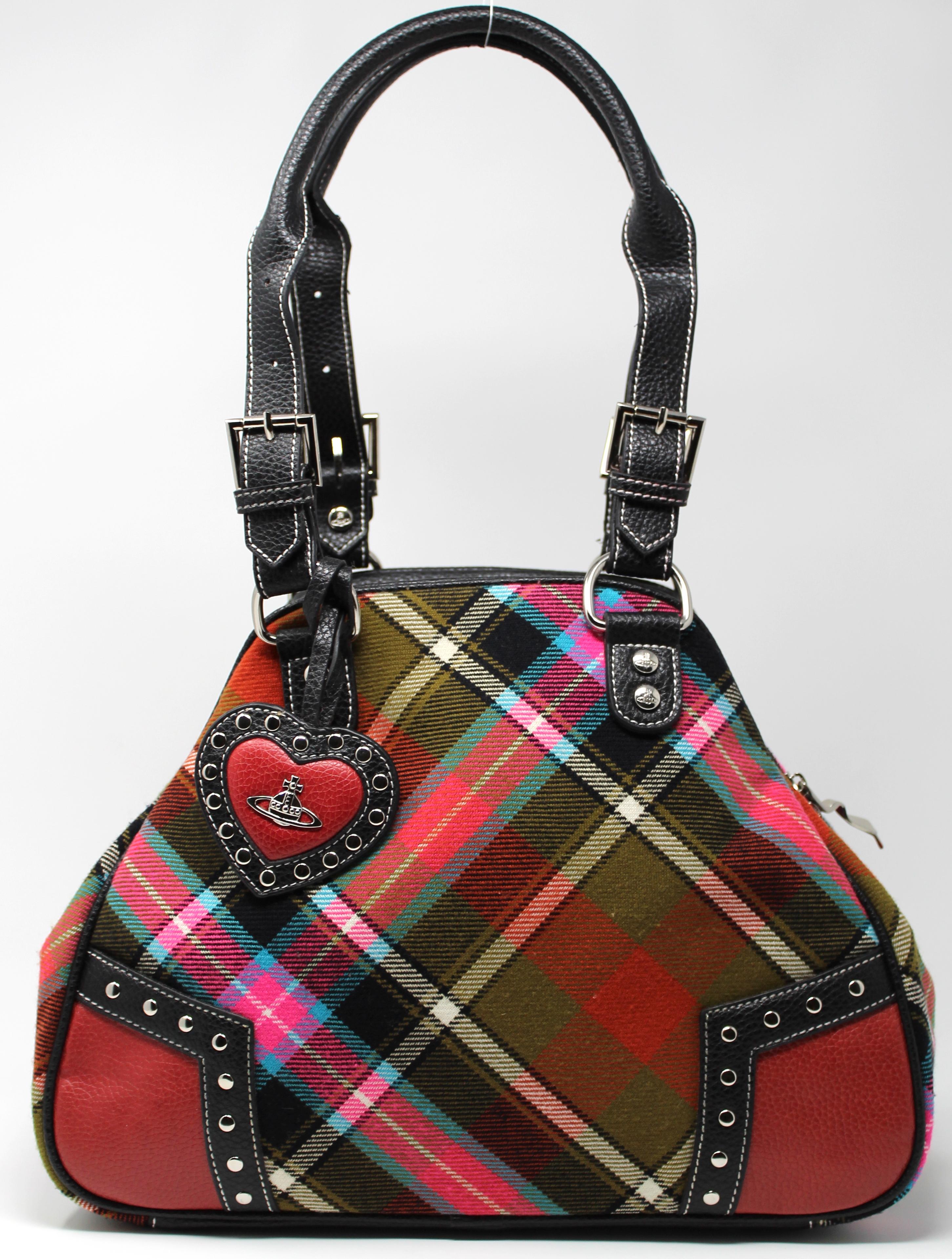 -Made in Italy, 100% genuine leather
-Tartan wool cloth, in array of colors
-Has hanging heart charm with studs all over
-All hardware is branded, grey orb lining
-Zip closure, one zip compartment inside

Condition:
-Good, shows minor signs of wear.