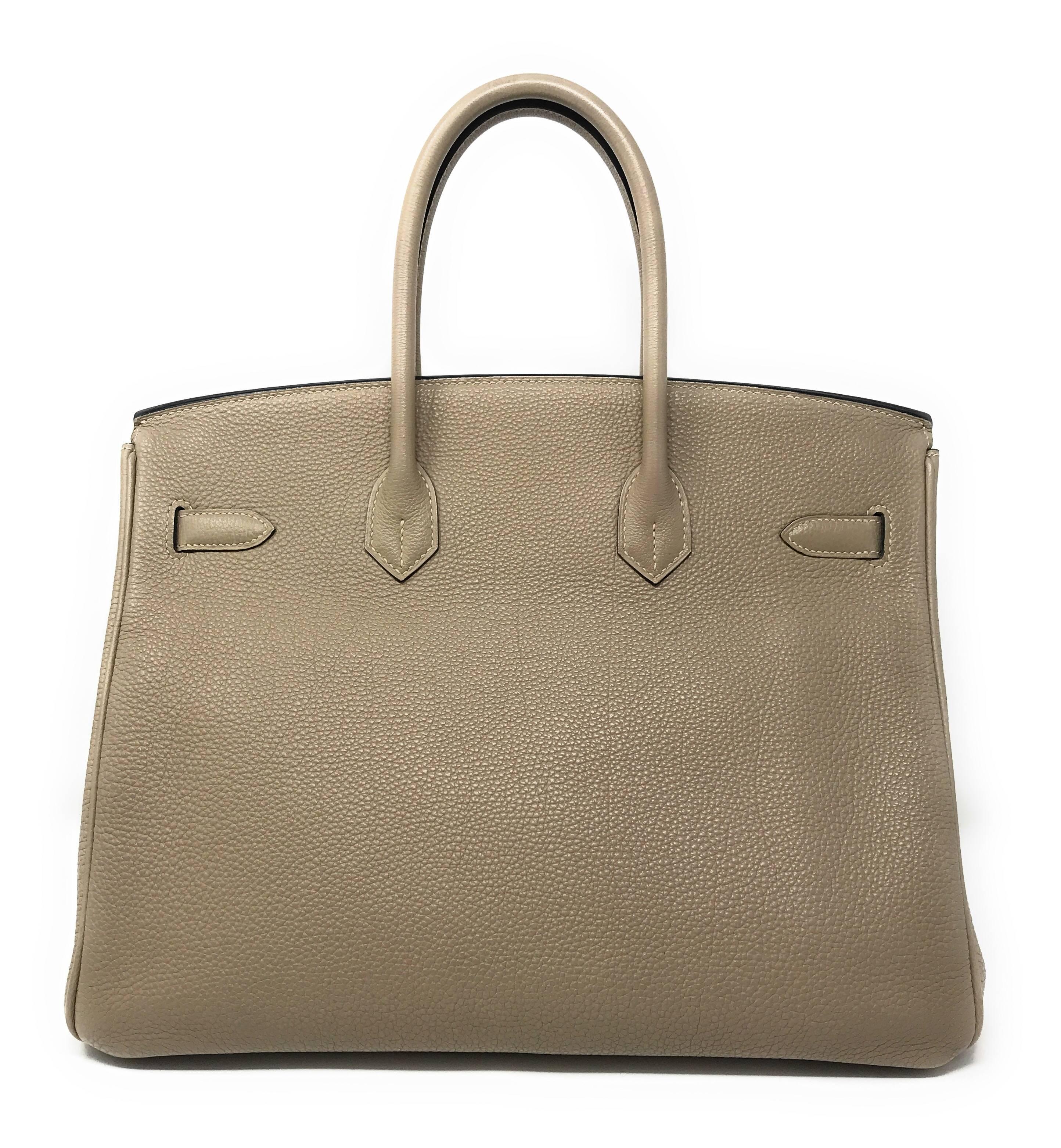 Hermes Gris Tourterelle, Turtle Dove Grey, is a mix of grey, beige, and taupe.
A true neutral that seems to change its tone and shade depending on the color of clothing it’s accessorized with.

This 35cm Birkin is crafted in Hermes Togo leather