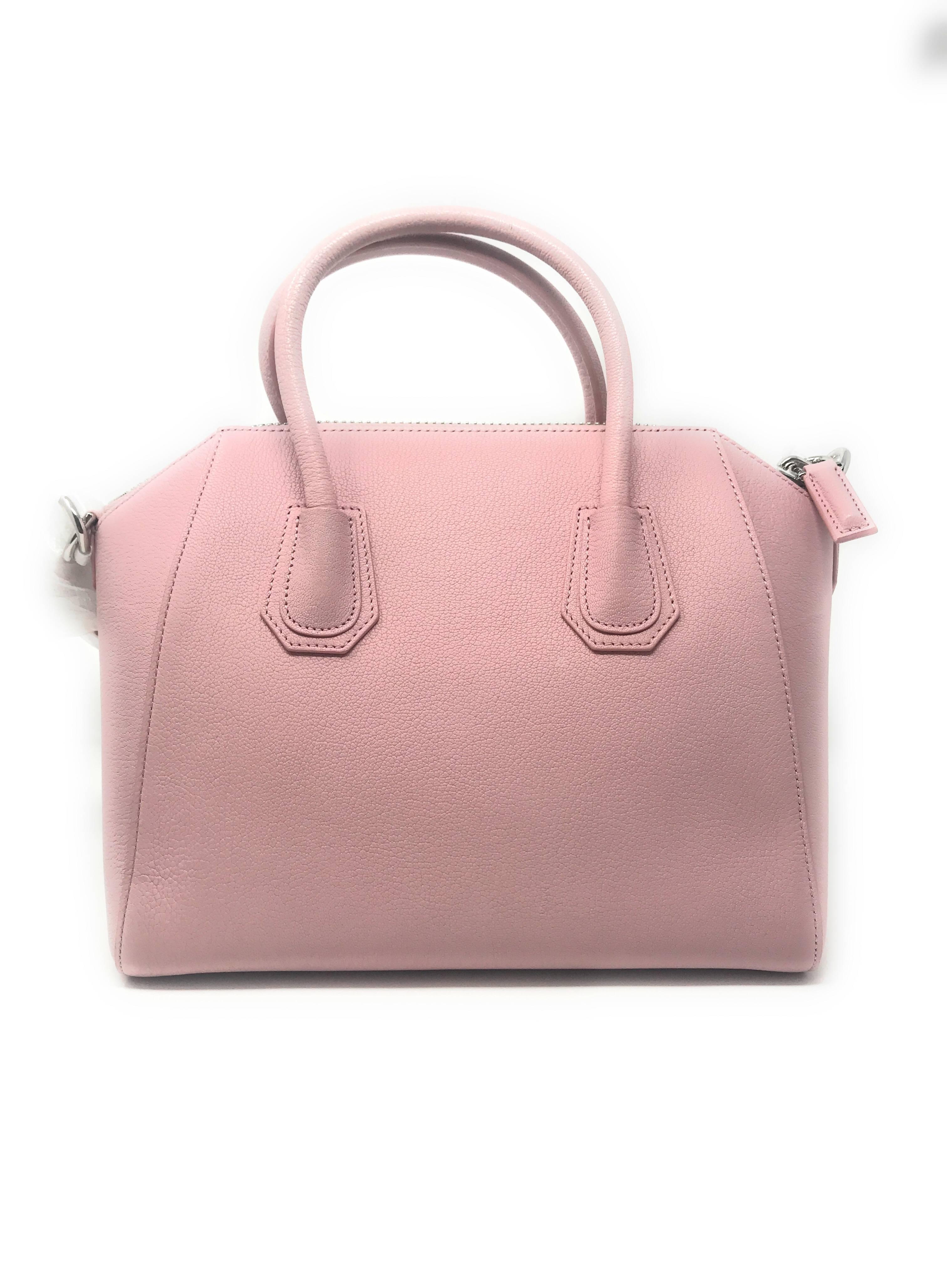 One of the most popular Givenchy designs, Antigona, in Baby Pink color. Expertly crafted in Italy from textured leather, it has a structured shape with 2 rolled top handles and a leather shoulder strap for versatility. It has a zippered top and is