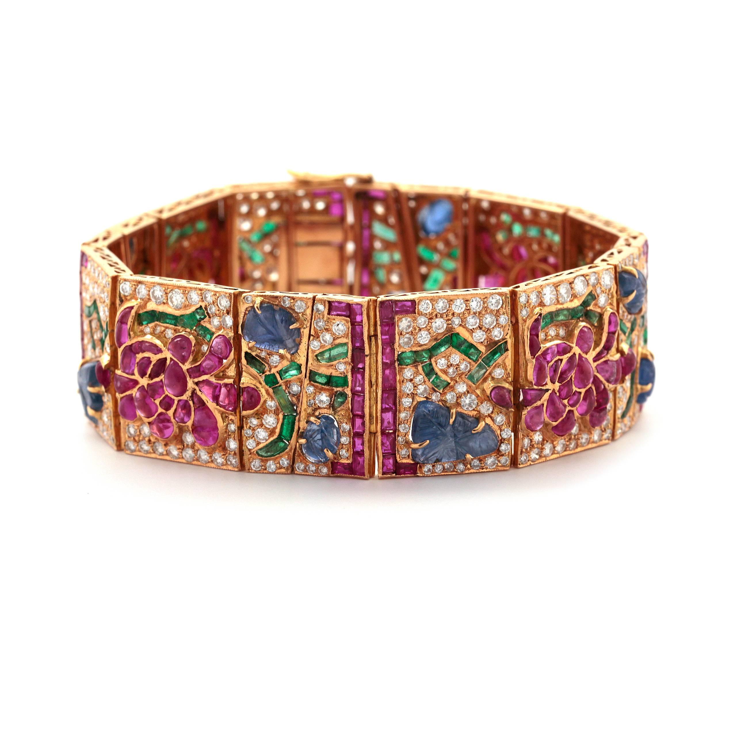 This stunning Yellow Gold Bracelet features diamonds and sapphires to create this beautiful flower design all around. 