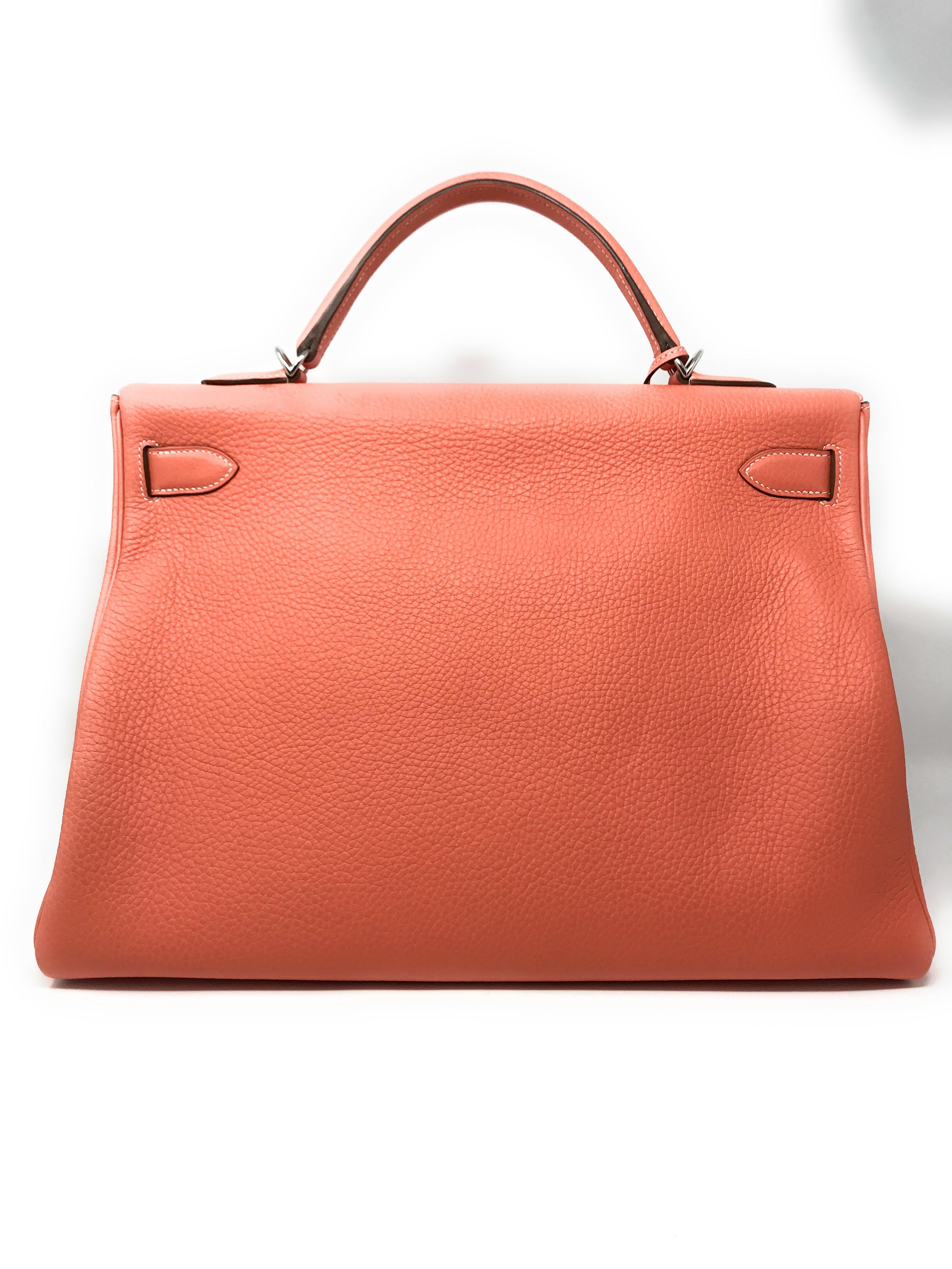 Rare Hermes Crevette is the color of this 40cm Kelly handbag. 
It is crafted in Clemence leather with a single handle, a flap closure and accented by Hermes signature Palladium hardware. The interior is lined with tonal Chevre leather, one zippered