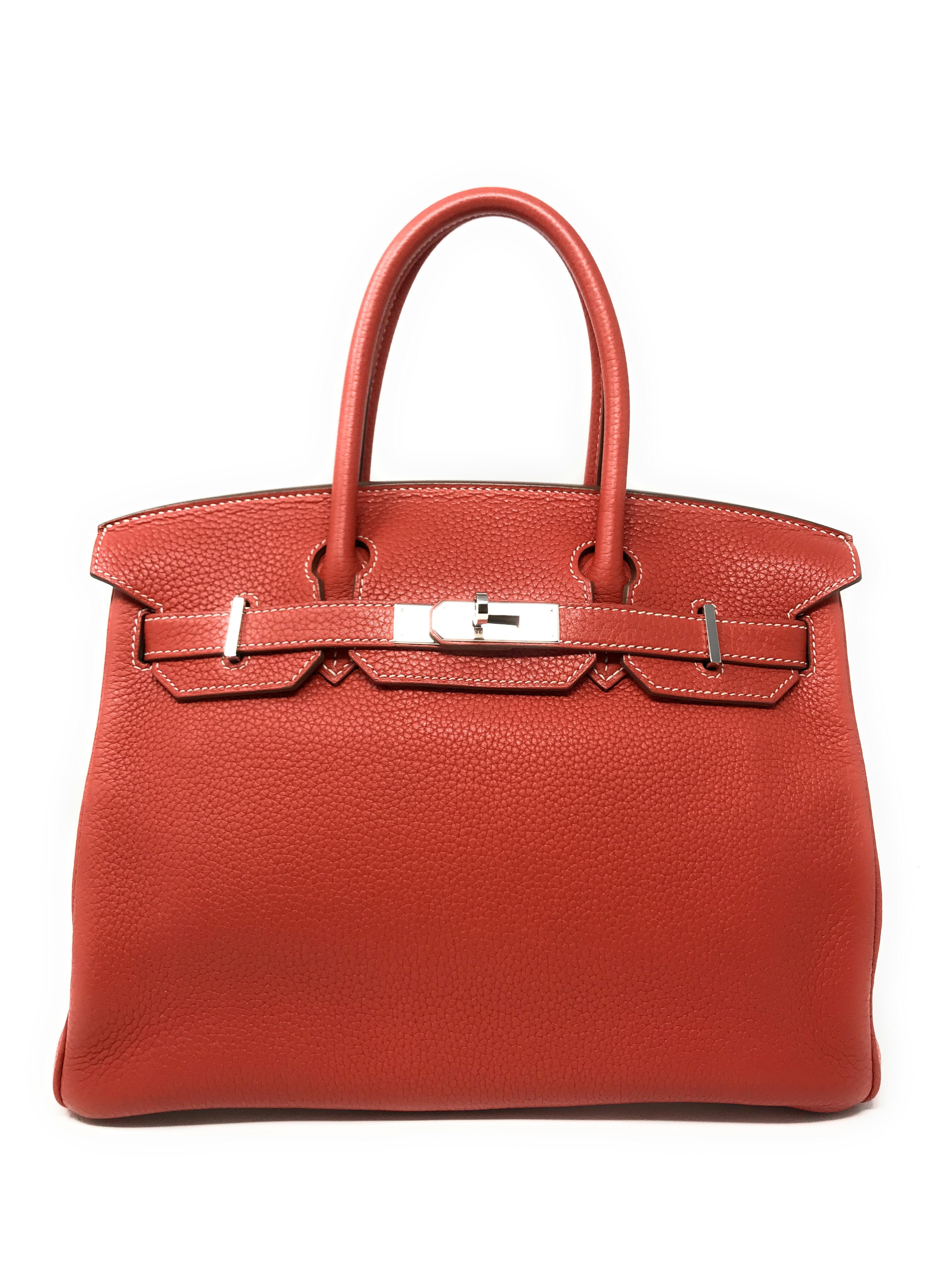 The iconic Hermes Birkin bag in a limited two tone edition of Sanguine and Blanc (white). This is the 30cm size which is in high demand because of its compact proportions that make it suitable for day or evening. It has dual rolled top handles, a