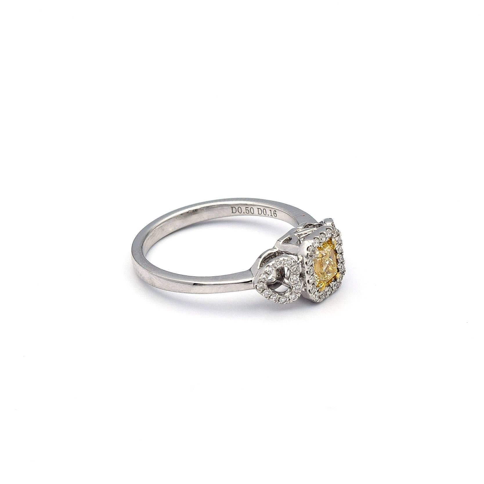 This charming ring has a 0.50ct Radiant cut Natural Yellow Diamond with 42 white pave diamonds weighting 0.16ct.

This ring is mounted in 18K White Gold, with two side heart shapes, giving it a total weight of 3.41 grams.

Ring size 6