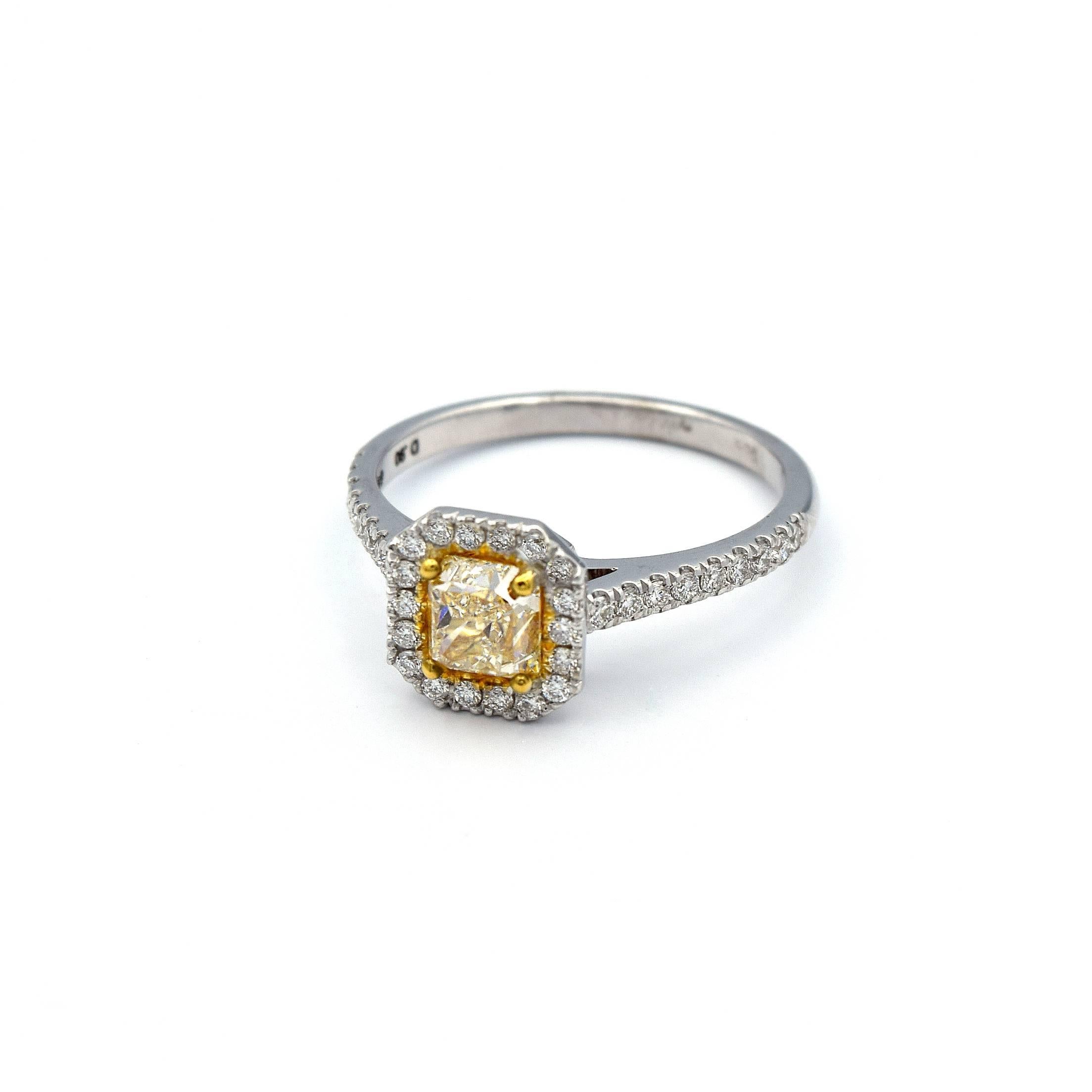 This ring has a gorgeous 0.90ct Radiant cut Natural Yellow Diamond with 36 White Diamonds all going around it. 

It is mounted in 14K White Gold and weights 2.69 grams total. 

Ring Size 6.5