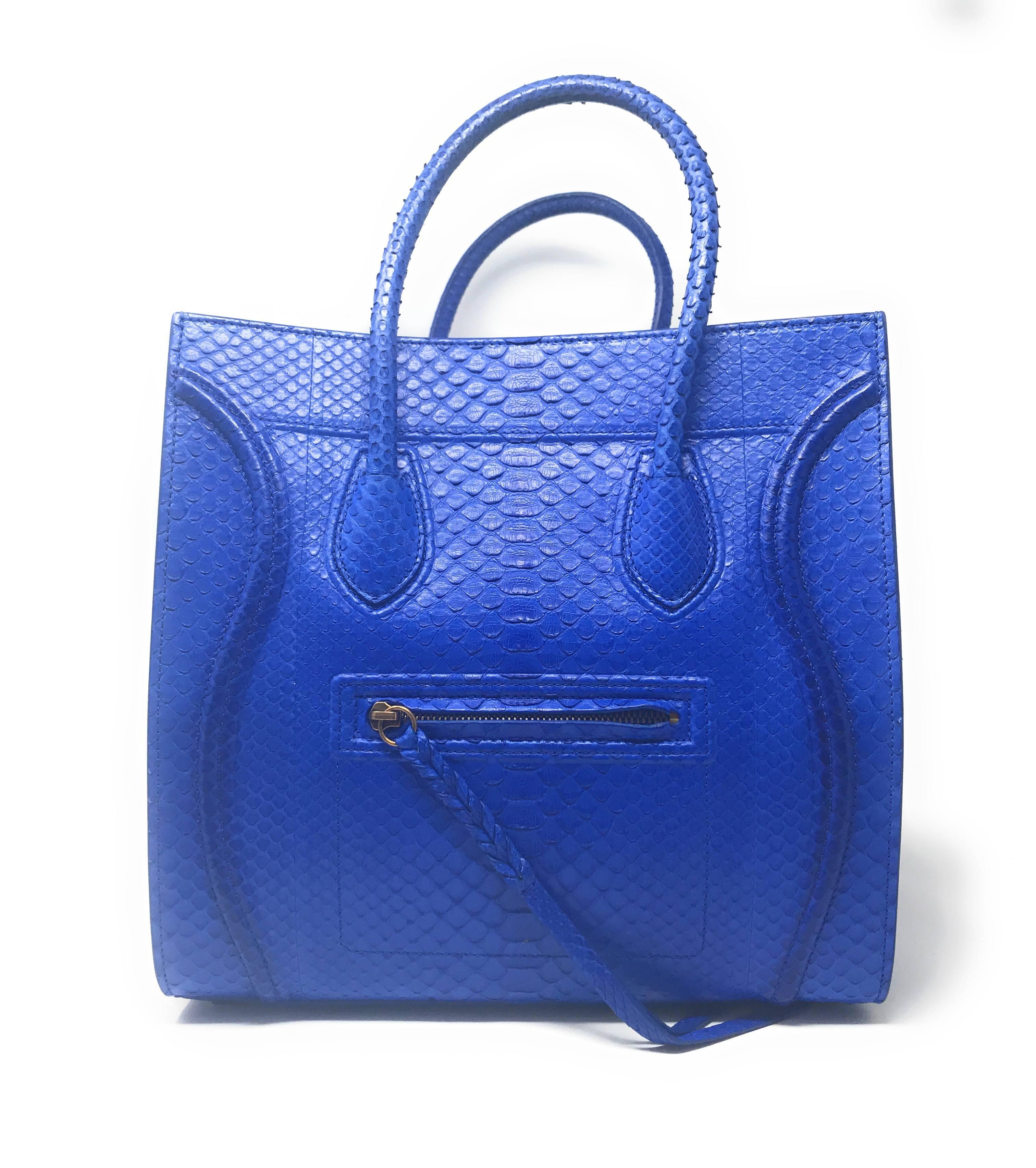 Celine Phantom in gorgeous and intense Blue Python skin, features the distinctive wings, sturdy handles, and braided zipper pull. This is the medium size which can be compacted by folding the wings inward. It has an exterior and an interior zippered