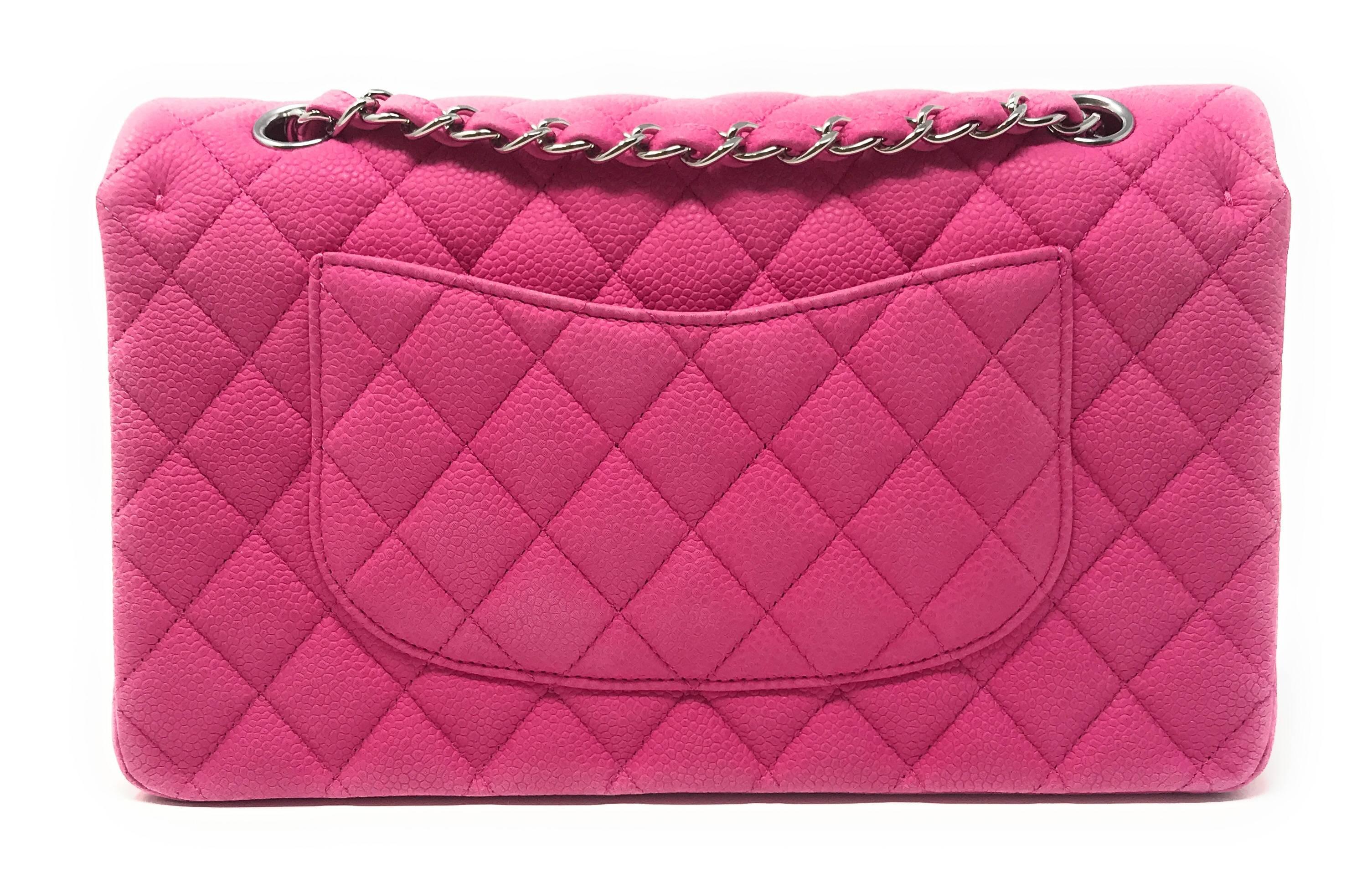 A pop of hot pink! The classic double flap Chanel bag crafted in hot pink matte caviar leather in the medium size. It features a frontal flap, multiple interior compartments and pockets (one zippered), back exterior slit pocket, and an adjustable