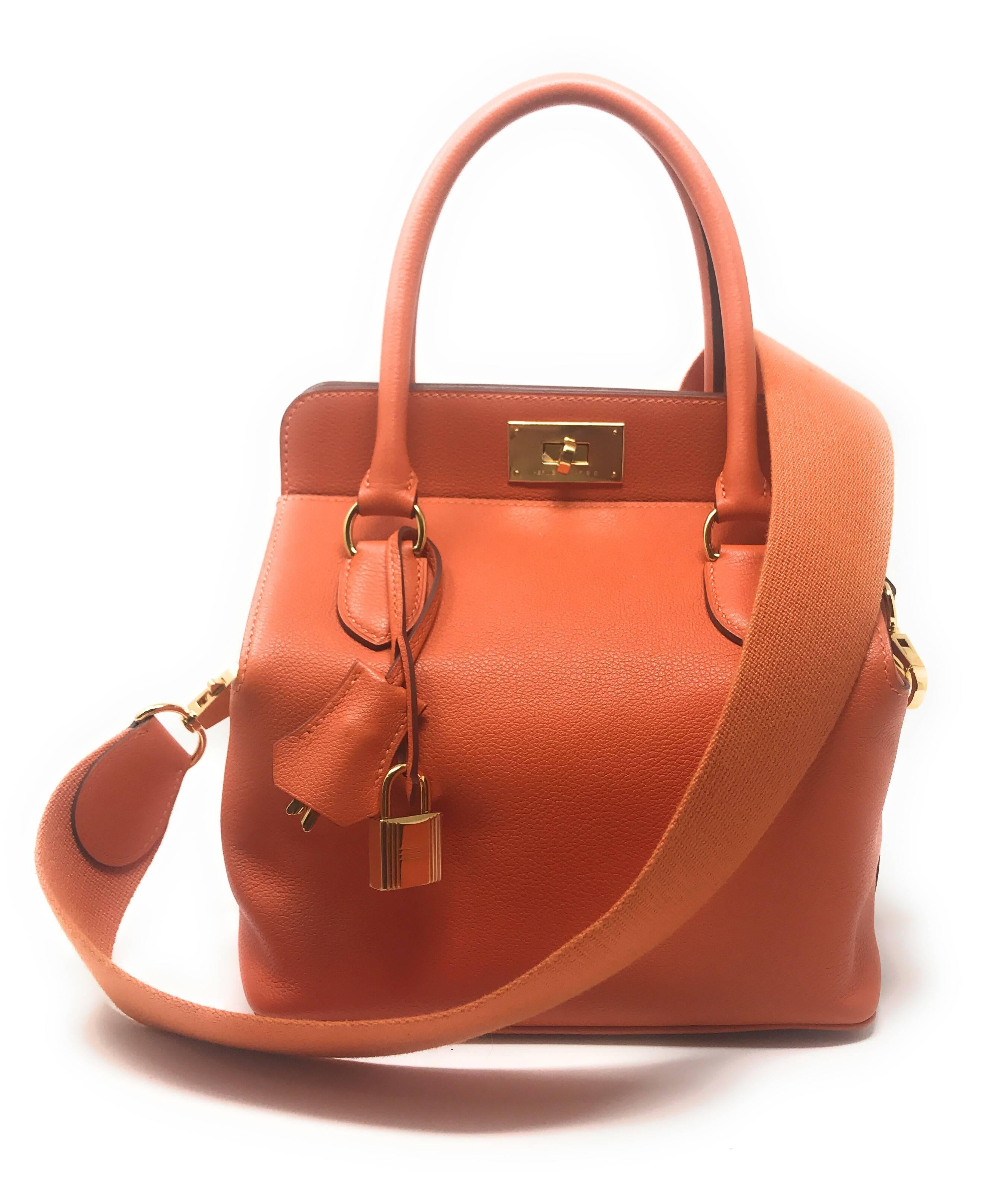 The Hermes Toolbox Tote Bag 20cm in Orange Feu (Fire) crafted in Evercolor leather with gold plated hardware. 
This bag’s debut was in 2010. It has 2 rolled top handles and the Hermes signature turn lock closure. It has a spacious interior with 3