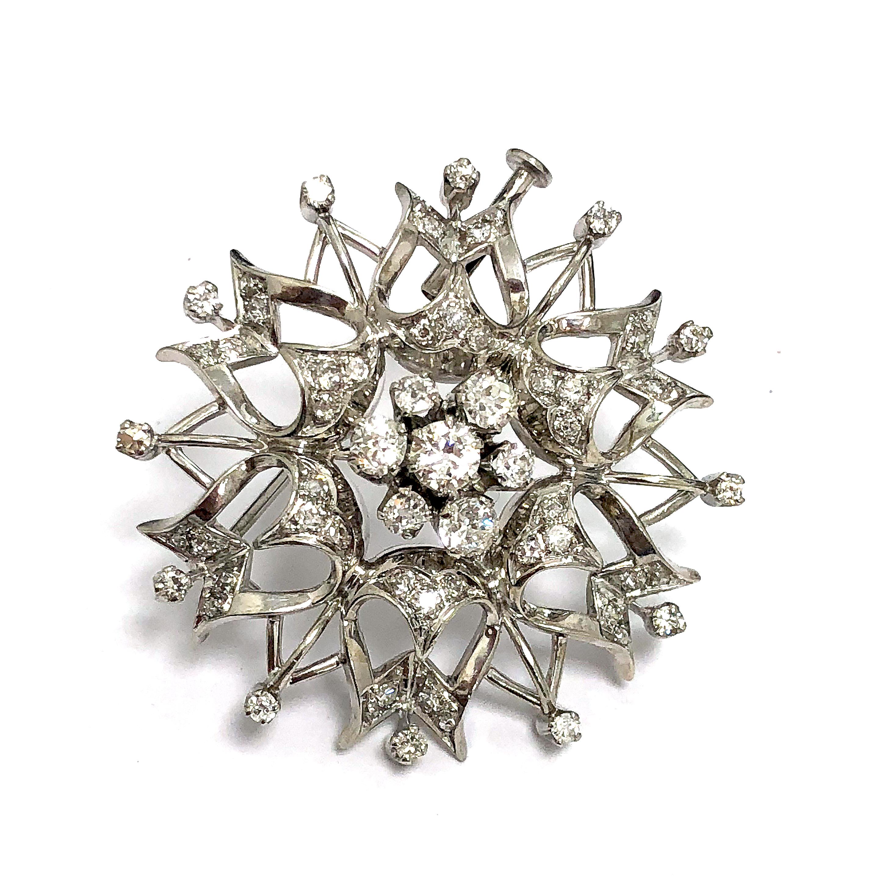 Flower shaped brooch / pin with approximately 3 carats of white diamonds. Has a length of 1.5in width and length. It is mounted in 14k White Gold.