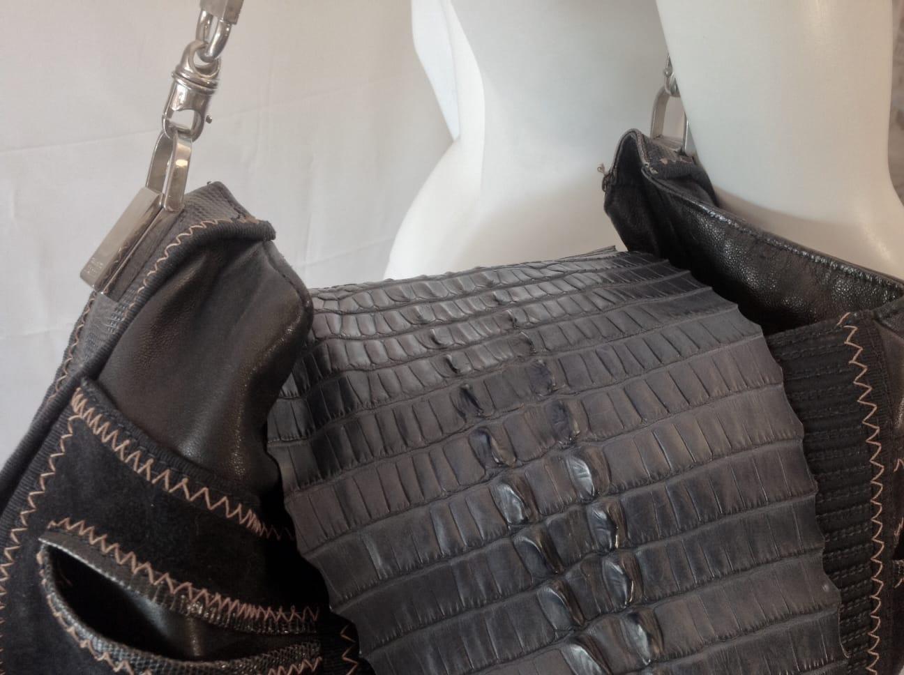 1990's vintage across body bag maxi size. Made in Italy.
The bag is composed of various types of fine leather. 
Externally: - the closure of the bags formed by a whole central part of crocodile in dark blue color - the central part in suede, with