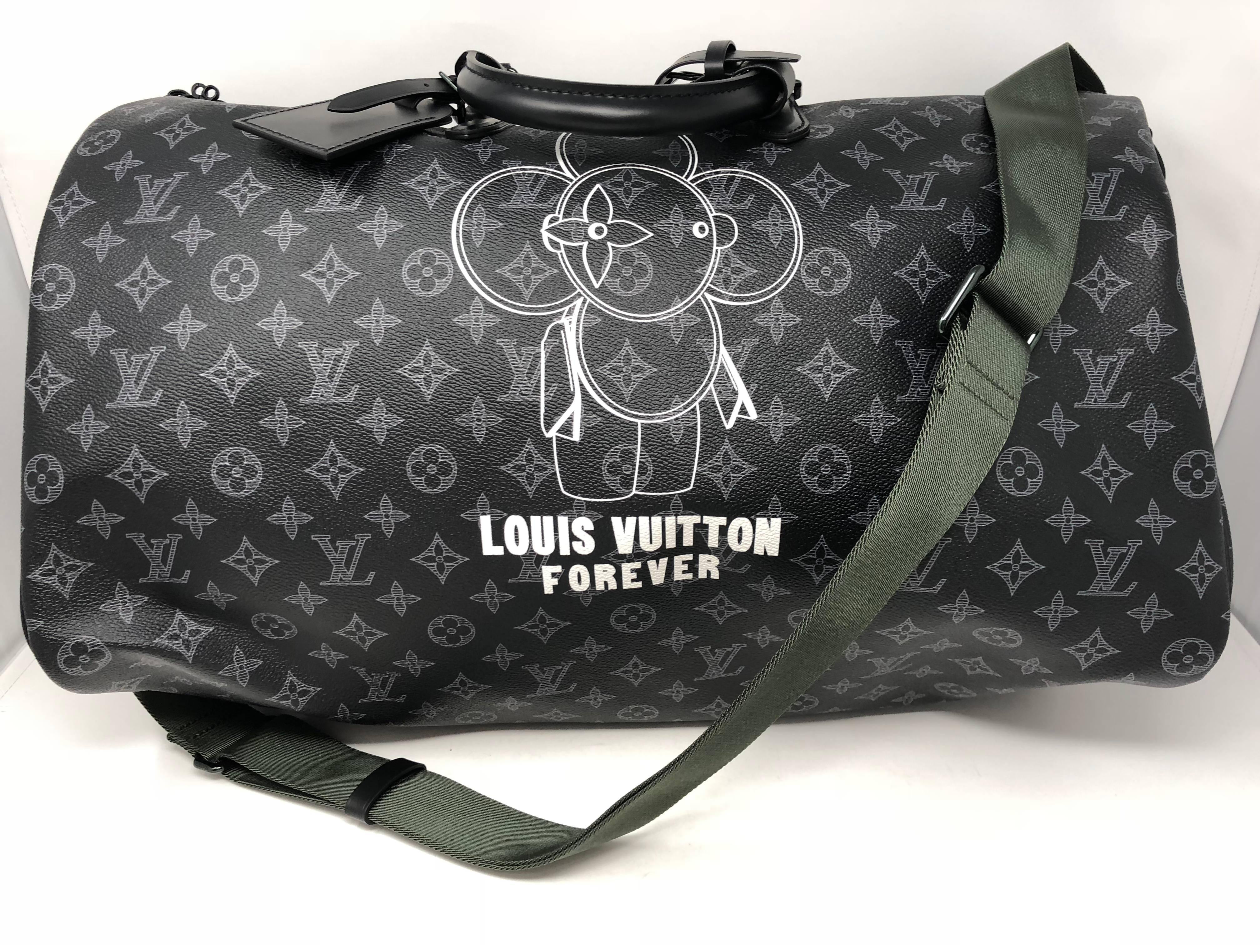 Louis Vuitton Monogram Eclipse Vivienne Keepall Bandouliere 50 with removable and adjustable strap. Louis Vuitton's Vivienne mascot is featured on the bag from the Pre-collection Fall-Winter 2018 line. Sold exclusively in Pop up locations and not