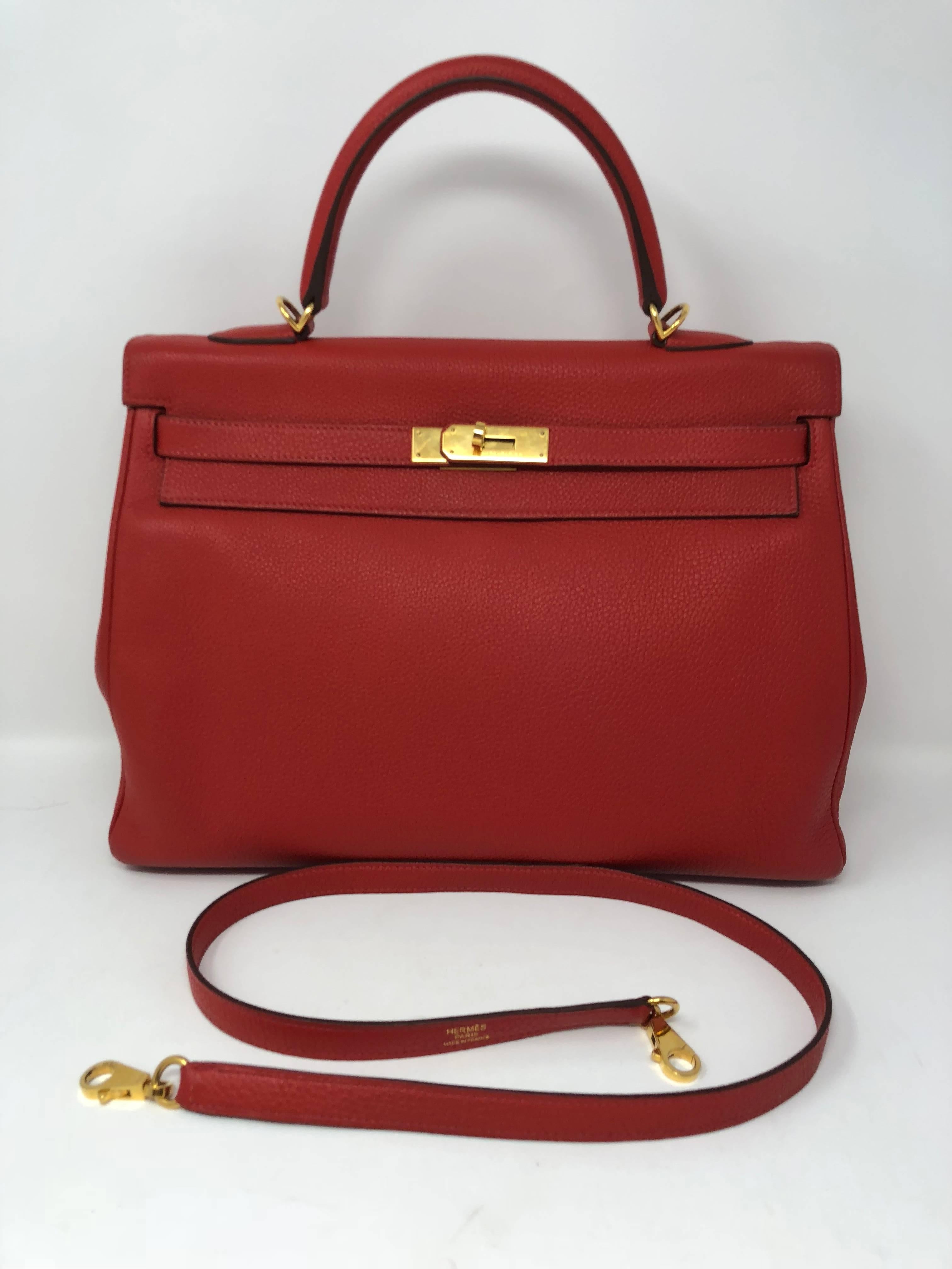 Hermes Kelly Retourne 35 Togo leather in Geranium red color with strap. Gold hardware. Made in 2012. Great condition. 