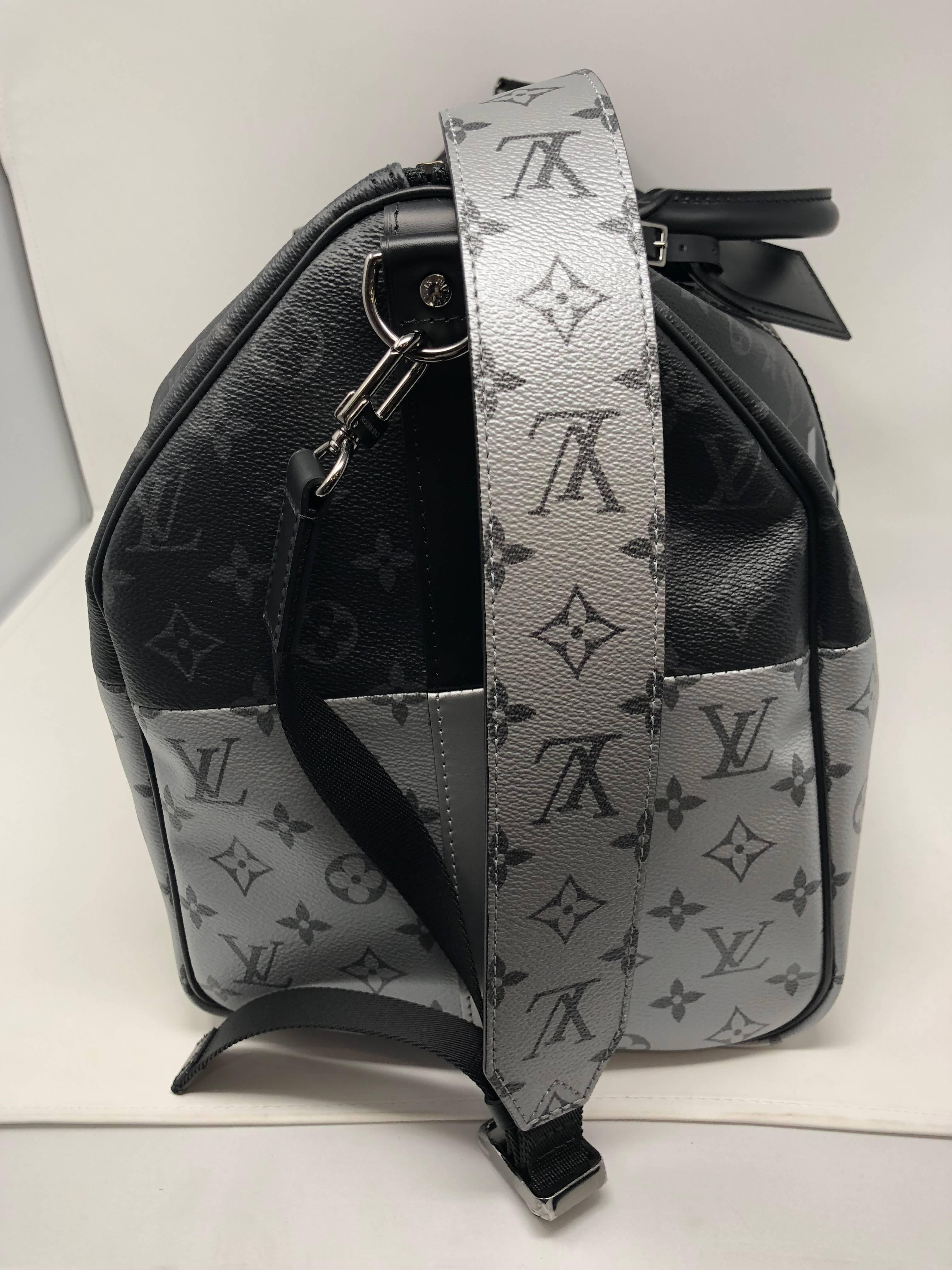 Authentic and Brand new Louis Vuitton Monogram Eclipse Split 50 Keepall Bandouliere. Coated monogram Eclipse split silver and black color. Black textile lining with cowhide leather trimming. New Spring 2018 Collection by Kim Jones and his last with