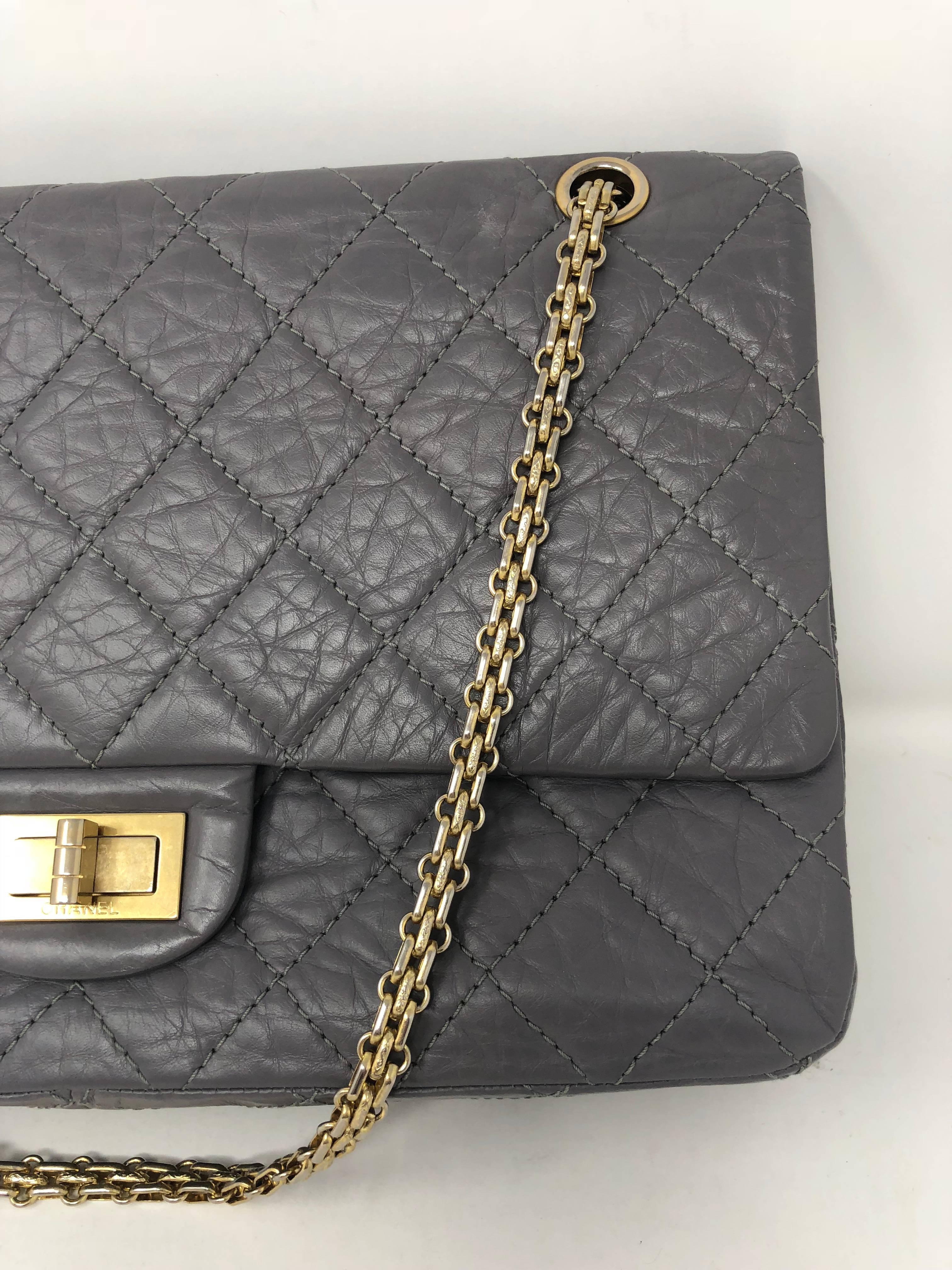 Chanel Gray Reissue Aged Calfskin distressed leather 2.55 double flap. Features a gold chain shoulder strap that can be worn doubled as a shoulder bag or as a crossbody. Gold Mademoiselle squared turn lock. The leather is crafted with aged calfskin