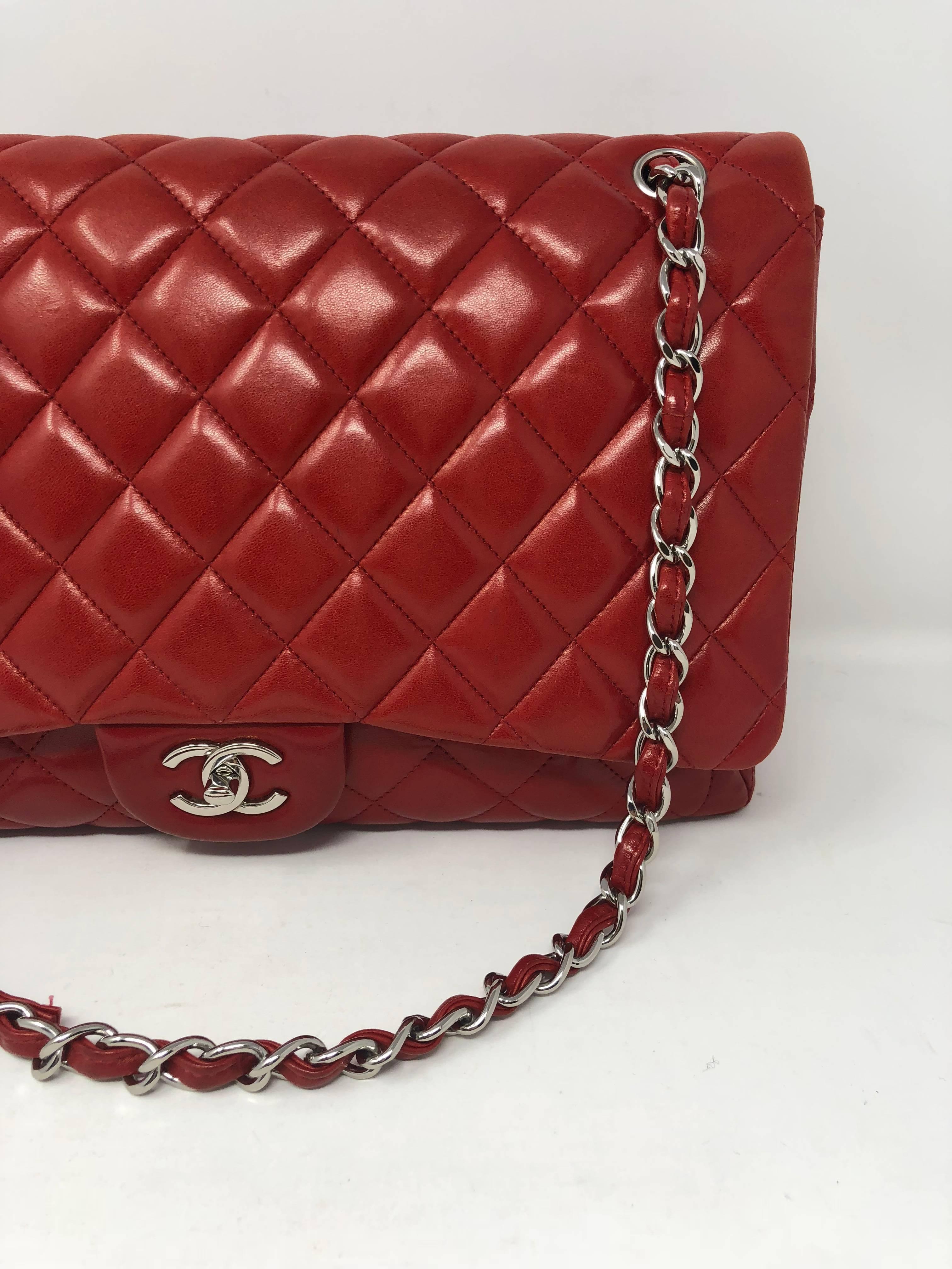 Red Chanel Maxi Single Flap Bag in lambskin leather. Silver hardware and can be worn doubled chain on the shoulder or as a crossbody bag. Has some wear but lots of life left. 
