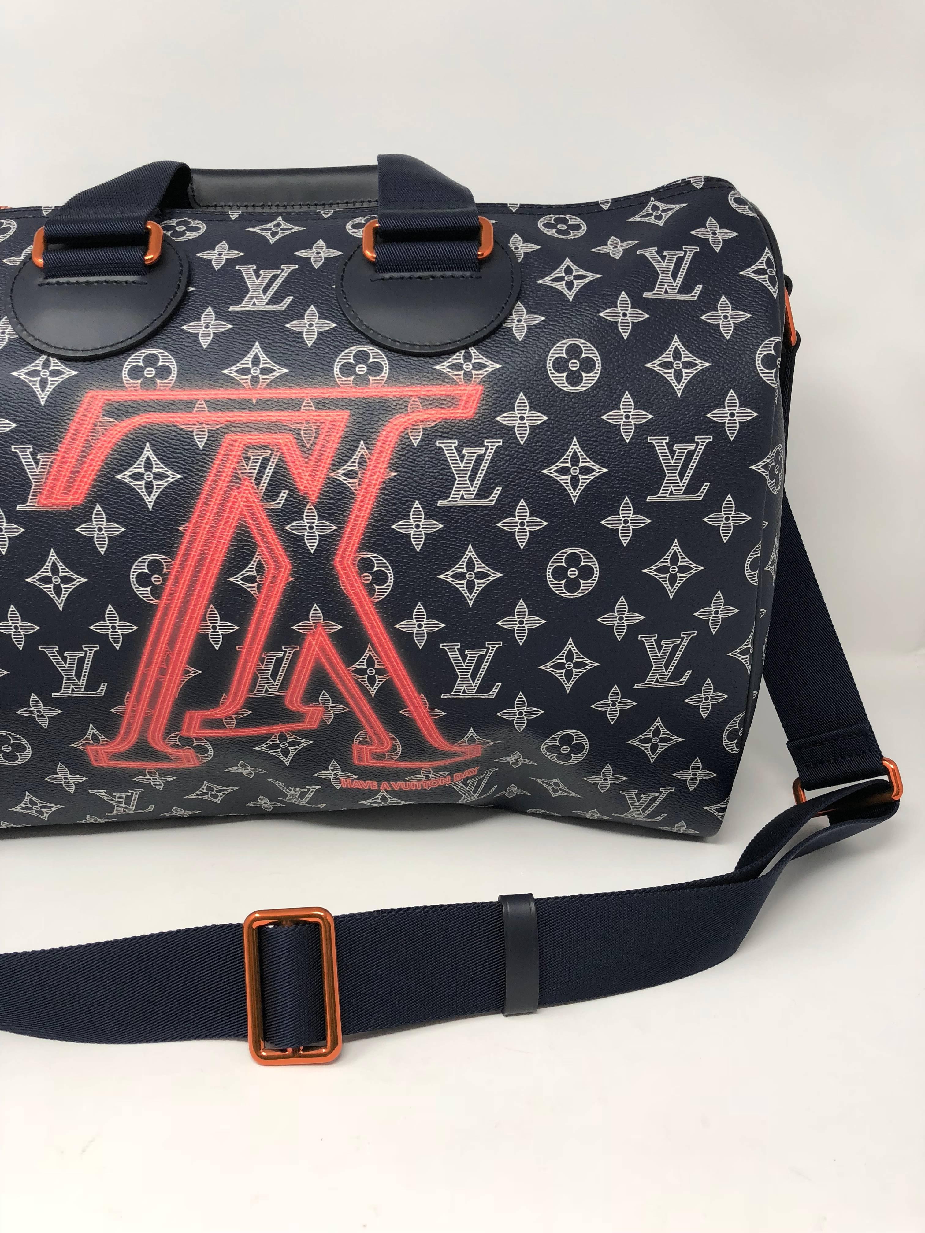 Louis Vuitton Speedy Bandouliere 40 with the Upside Down logo designed by Kim Jones for the Men's Fall 2018 Collection. Made of monogram ink coated canvas and pink metal hardware. Can be worn as a top handle or over the shoulder. Guaranteed