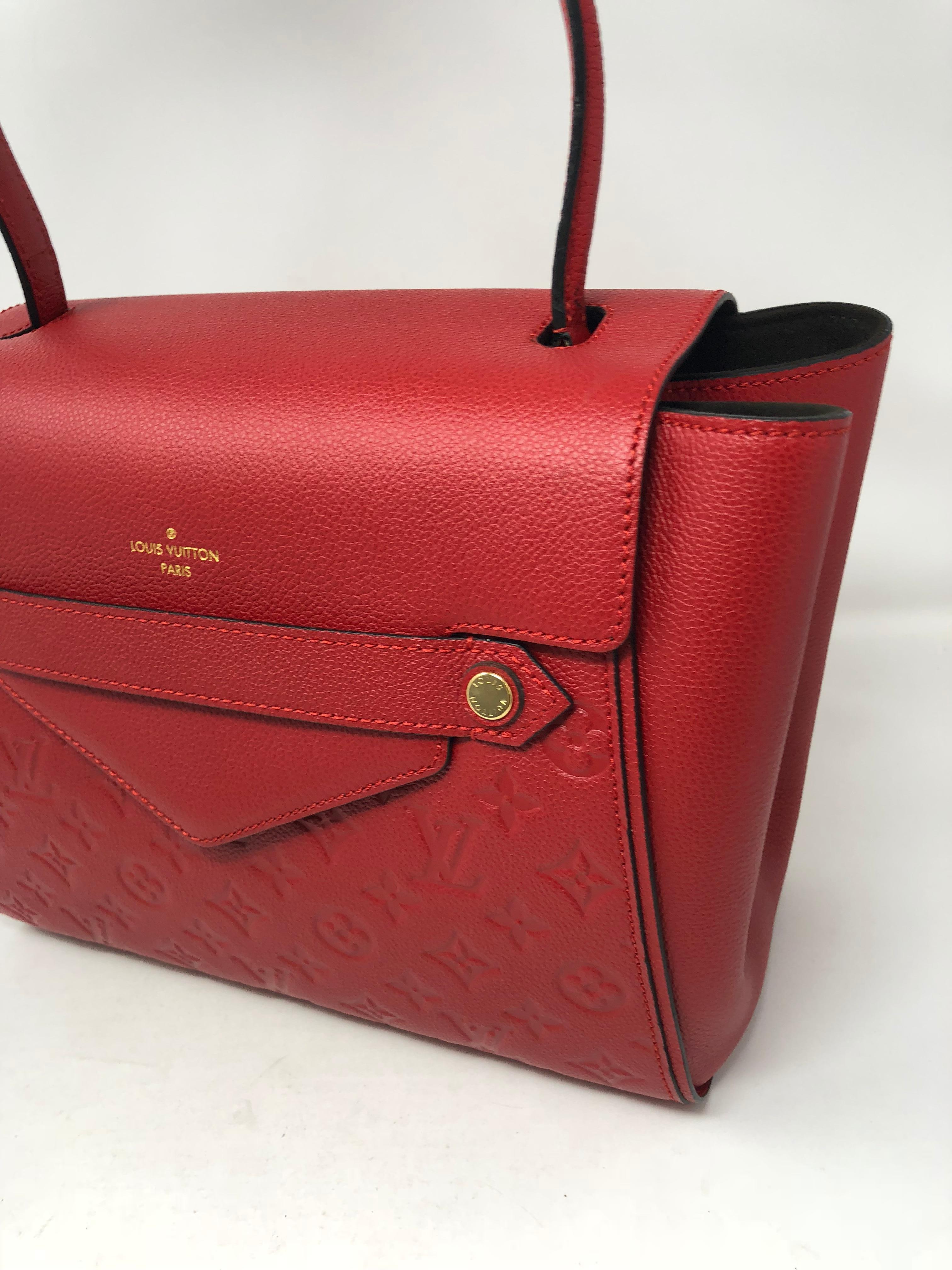 Red Louis Vuitton Monogram Trocadero bag in eimpreinte leather. Box style bag with one strap. Unique design and discontinued. Lady like style and can hold small laptop. 