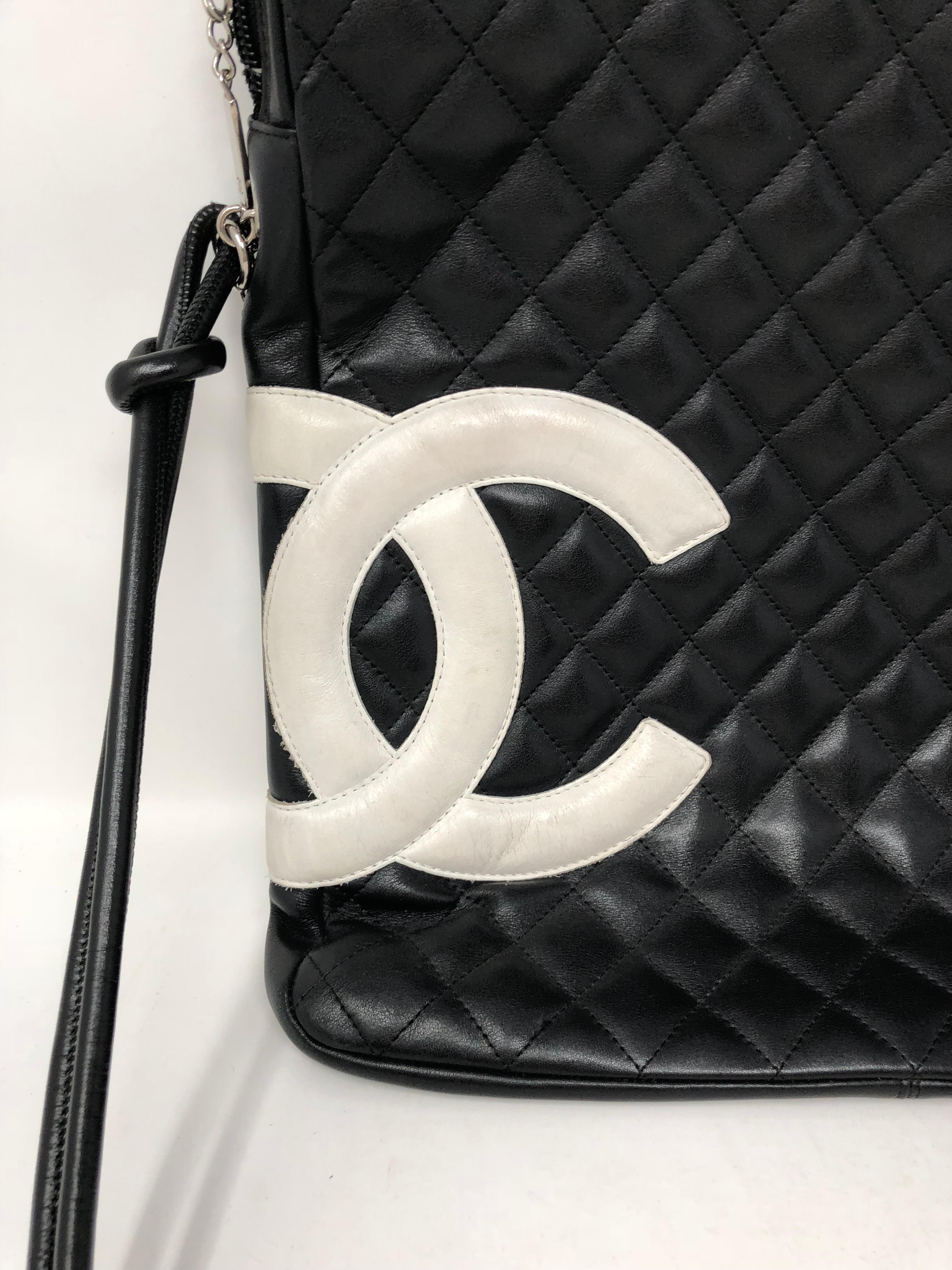 Chanel Black and white C's Cambon Crossbody Messenger bag. Hot pink nylon interior, has some wear inside. Dirt and normal wear. Exterior in good condition. Guaranteed authentic. 