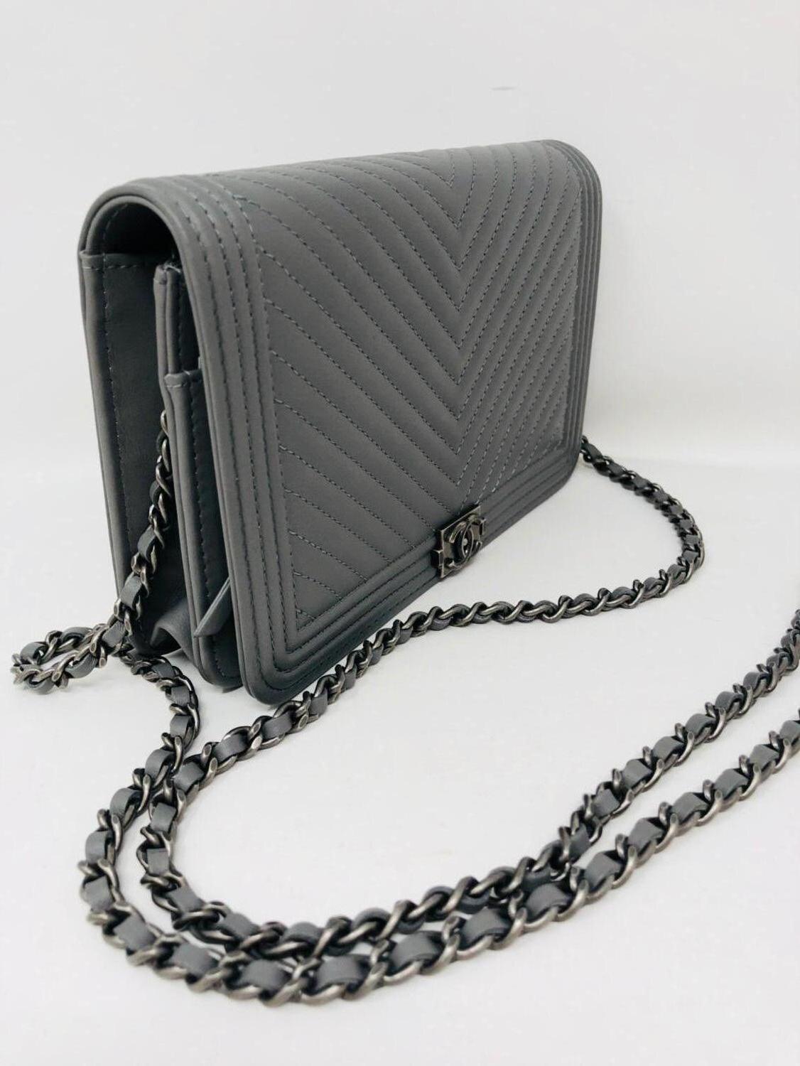 Chanel Boy Grey Wallet On A Chain with antique silver hardware. Can be worn as a wallet, clutch or crossbody bag. Brand new never worn. Comes with dust cover, authenticity card, and box. Guaranteed authentic. 