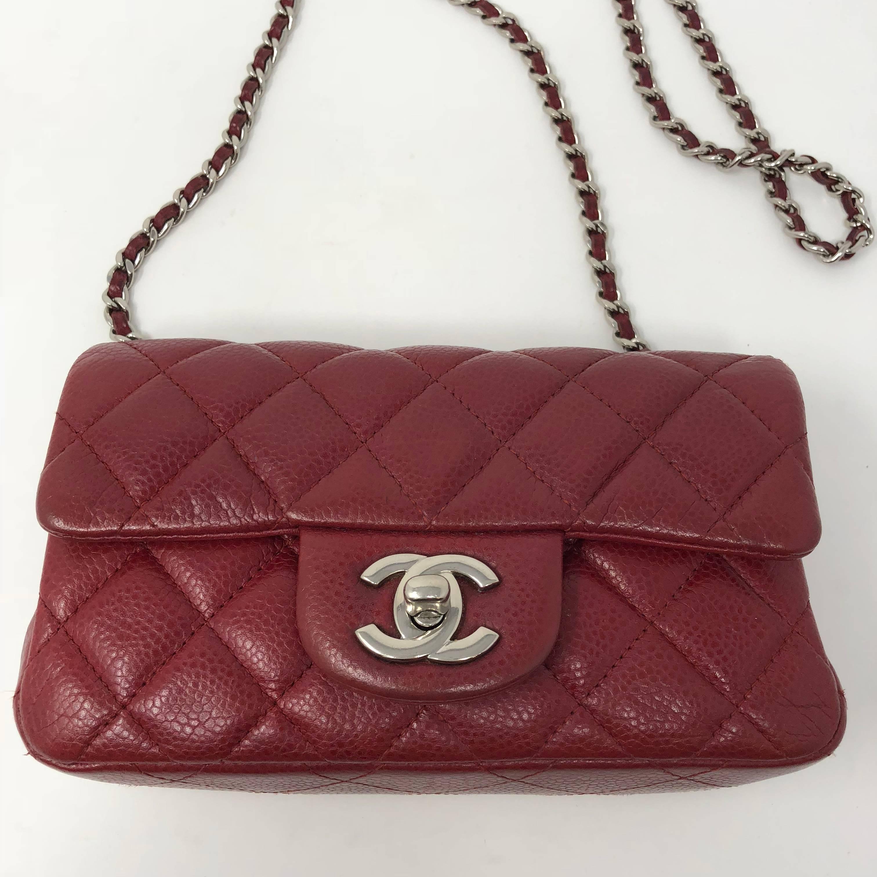 Extra mini size Chanel red crossbody bag in caviar leather. Silver hardware and in mint condition. From year 2012-2013. 