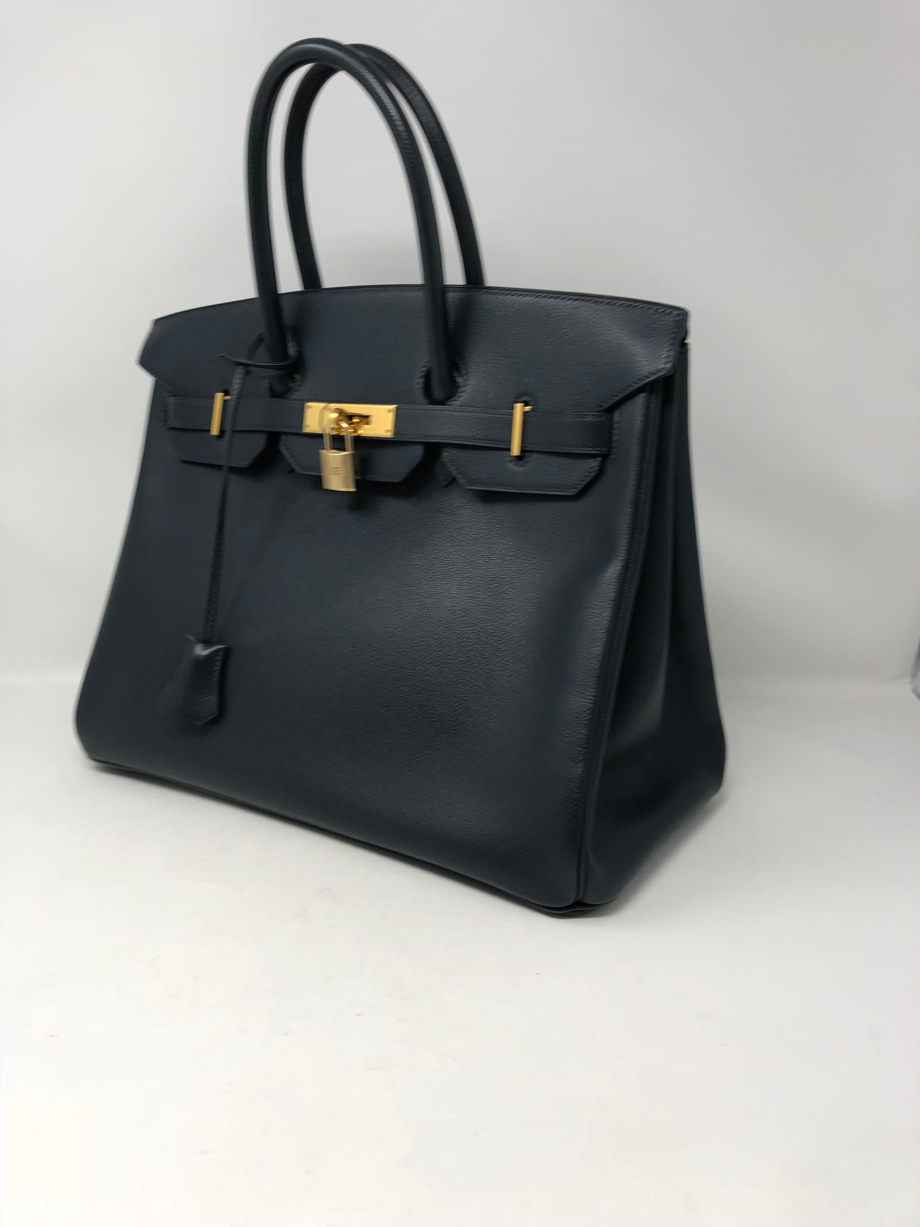 Hermes Navy Birkin 35 in courchevel leather. Gold hardware. Excellent condition. No slouch to the bag and stands up straight. Interior is mint as well. 