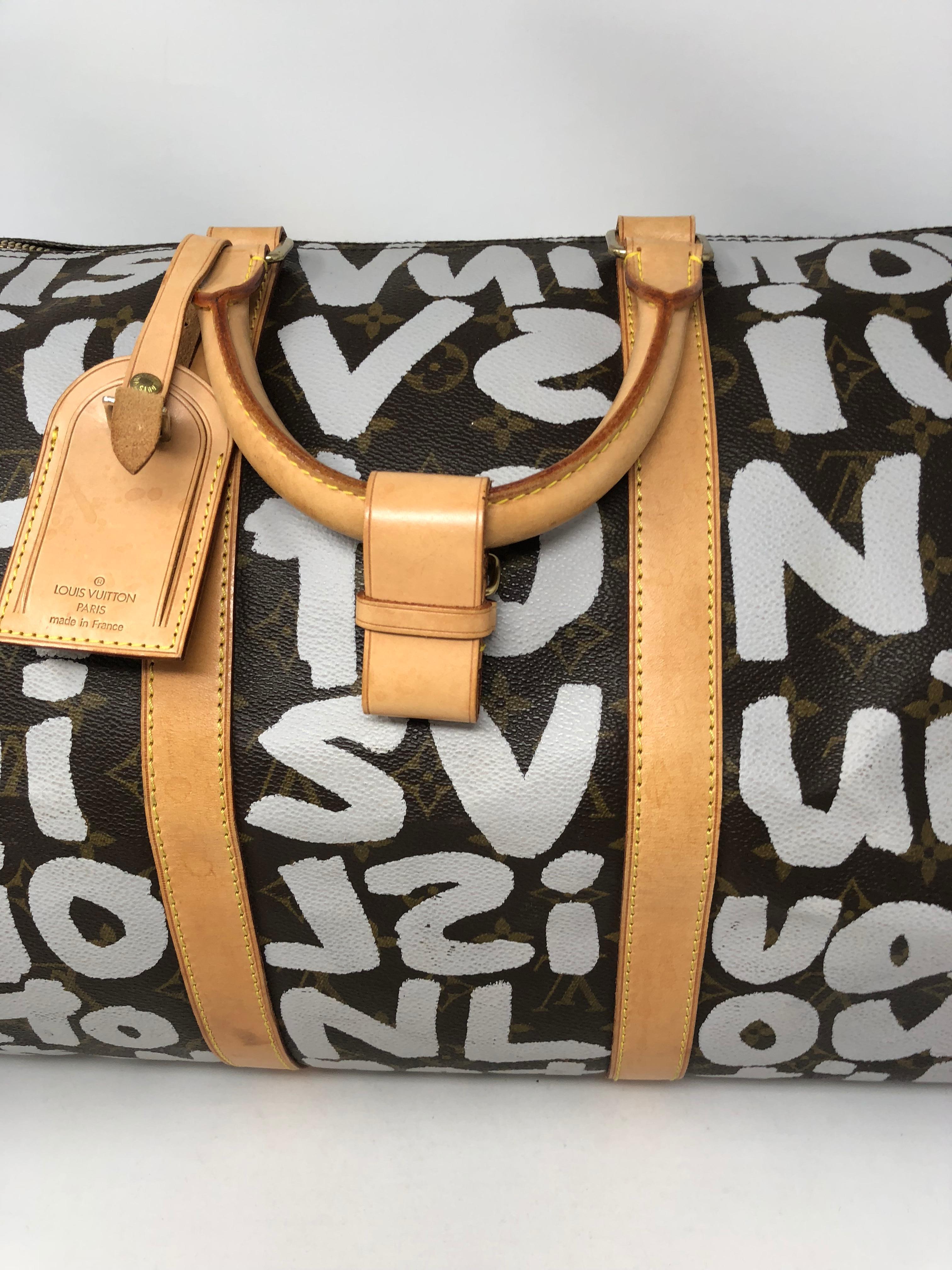 Louis Vuitton Graffiti Keepall 50 designed by artist Stephen Sprouse. Monogram canvas with white lettering throughout. Iconic design by famous artist the Graffiti keepall is a must for LV collectors. Has some normal vintage wear but has lots of life