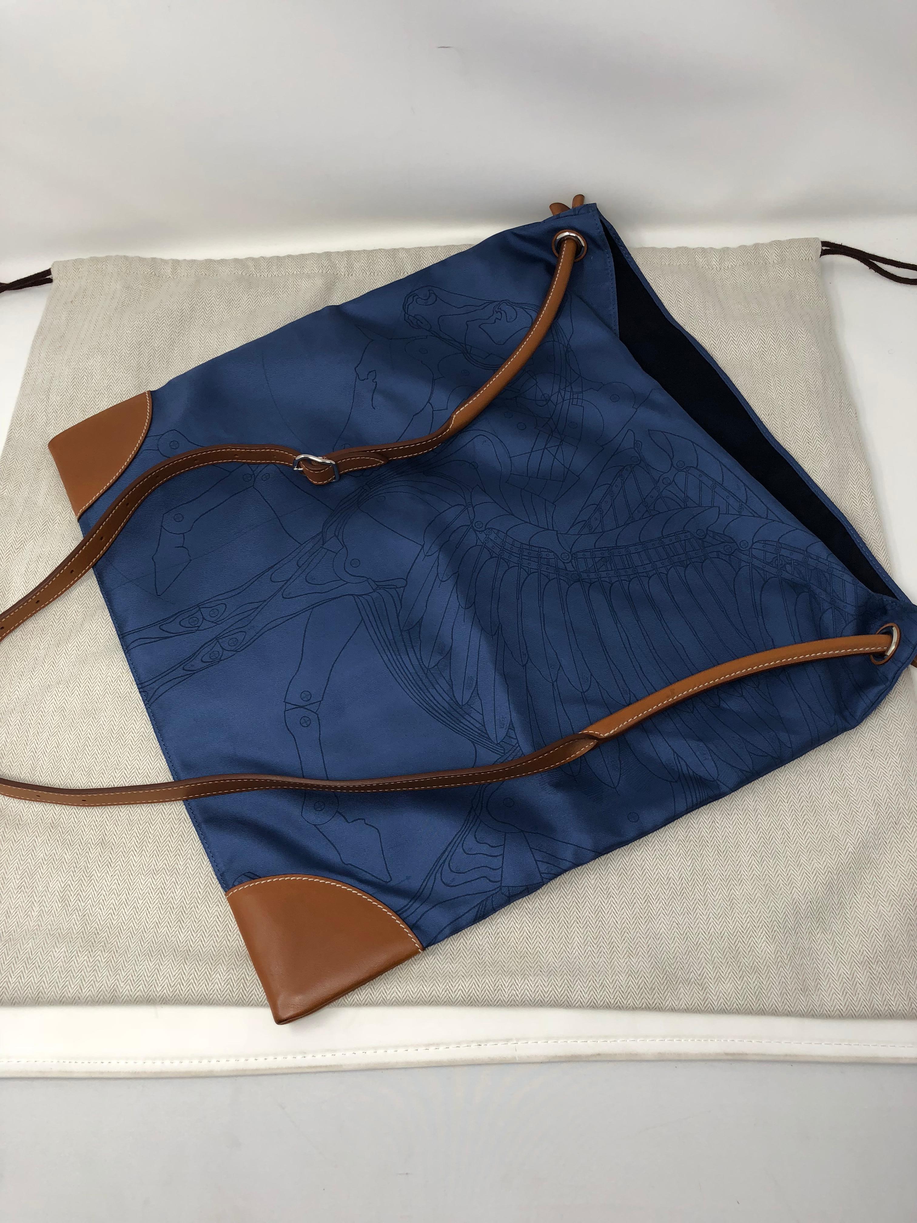 Hermes Blue Silky City Bag. Beautiful blue Silk fabric bag with horse motif design. The Silky City bag from Hermes is not only strong but made to be thin and lightweight. The leather strap is made from natural barenia calfskin with all the highest