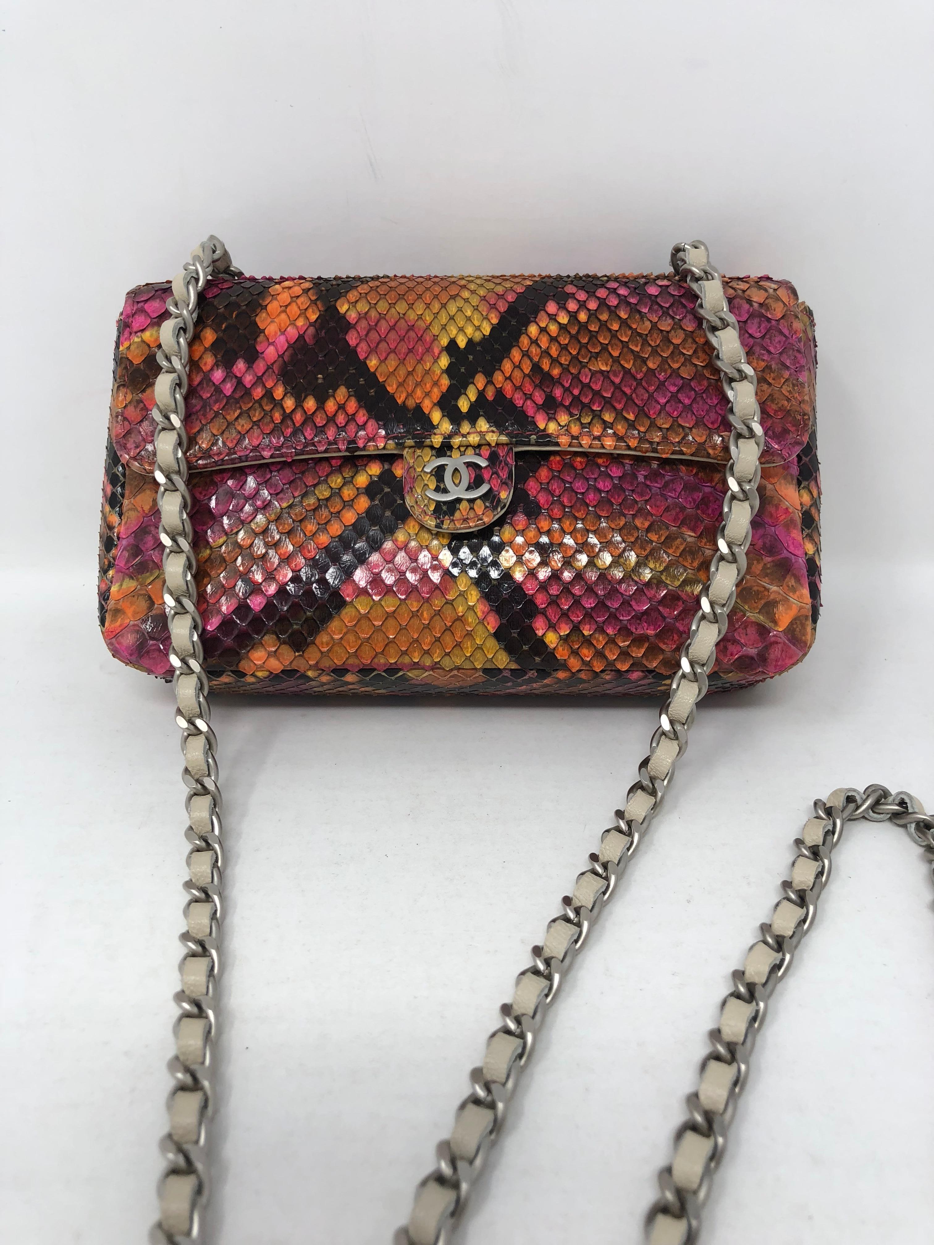 Chanel Python Mini Evening Bag in pink ,orange, yellow and black. Mint condition like new. All leather interior with white leather chain links. No wear on the python. Unique pattern and design python mini. Silver hardware. Can be worn as a