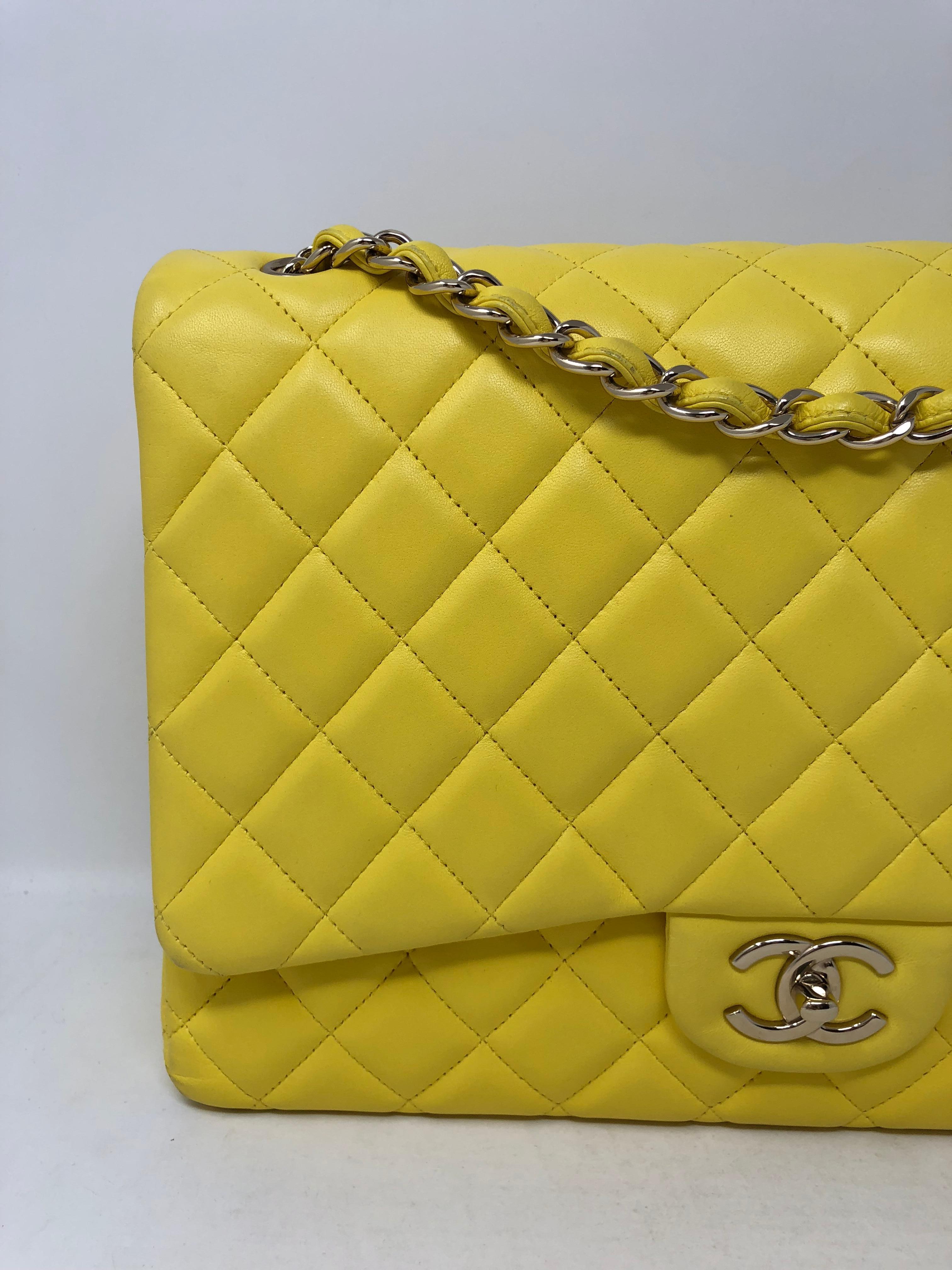 Chanel Canary Yellow Maxi Double Flap lambskin Bag with silver hardware. Bright yellow and good condition bag that can also be worn crossbody. Or doubled to wear as a shoulder bag. Stunning color and all leather. Add this to your Chanel collection.