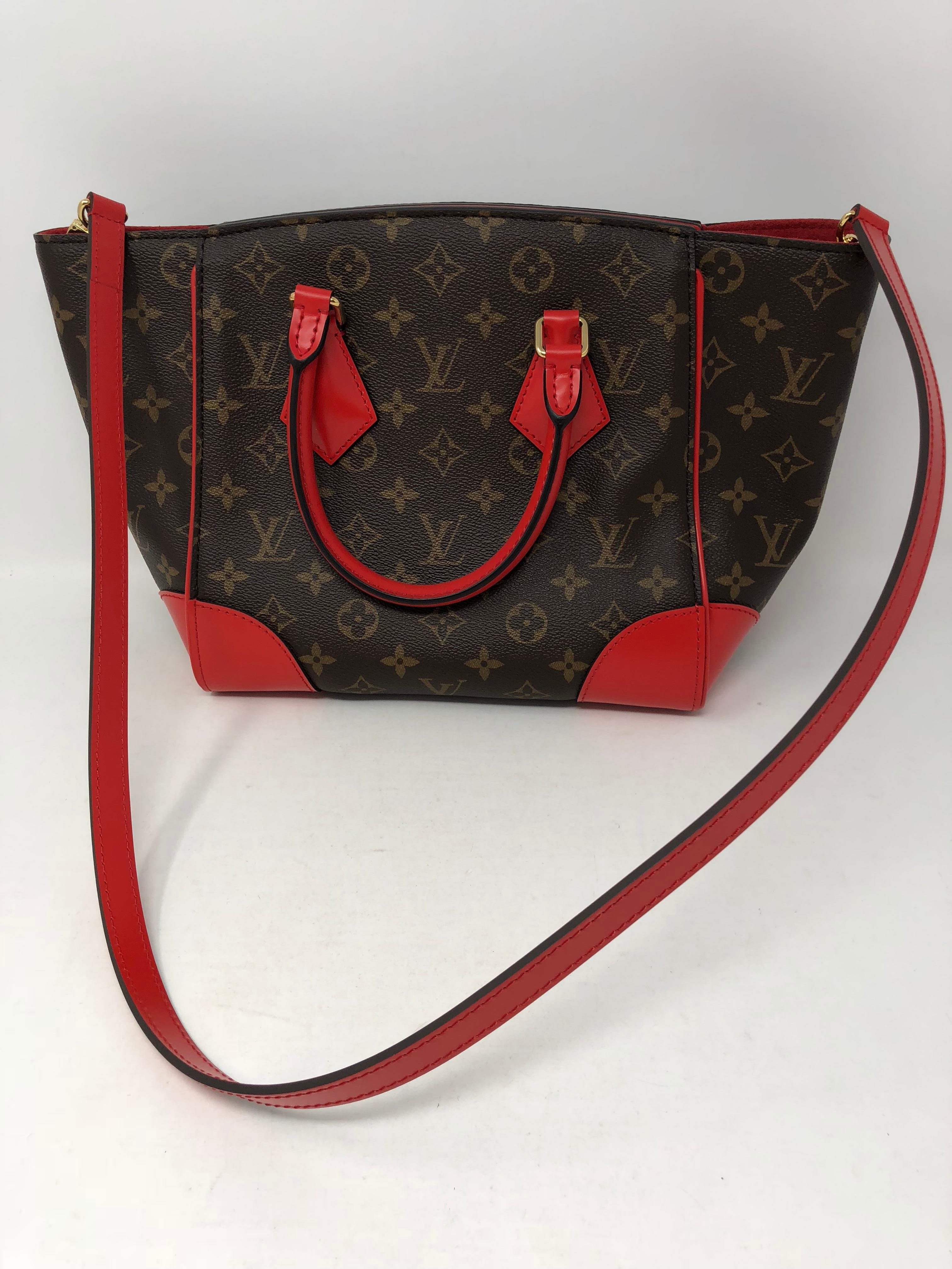 Loui Vuitton Phenix PM in Coquelicot (Red)  Monogram with red leather trim and shoulder bag. Classic tolie monogram canvas and red calfskin leather details on the bag. Gold hardware. Spacious and versatile bag with a hidden magnet that opens and