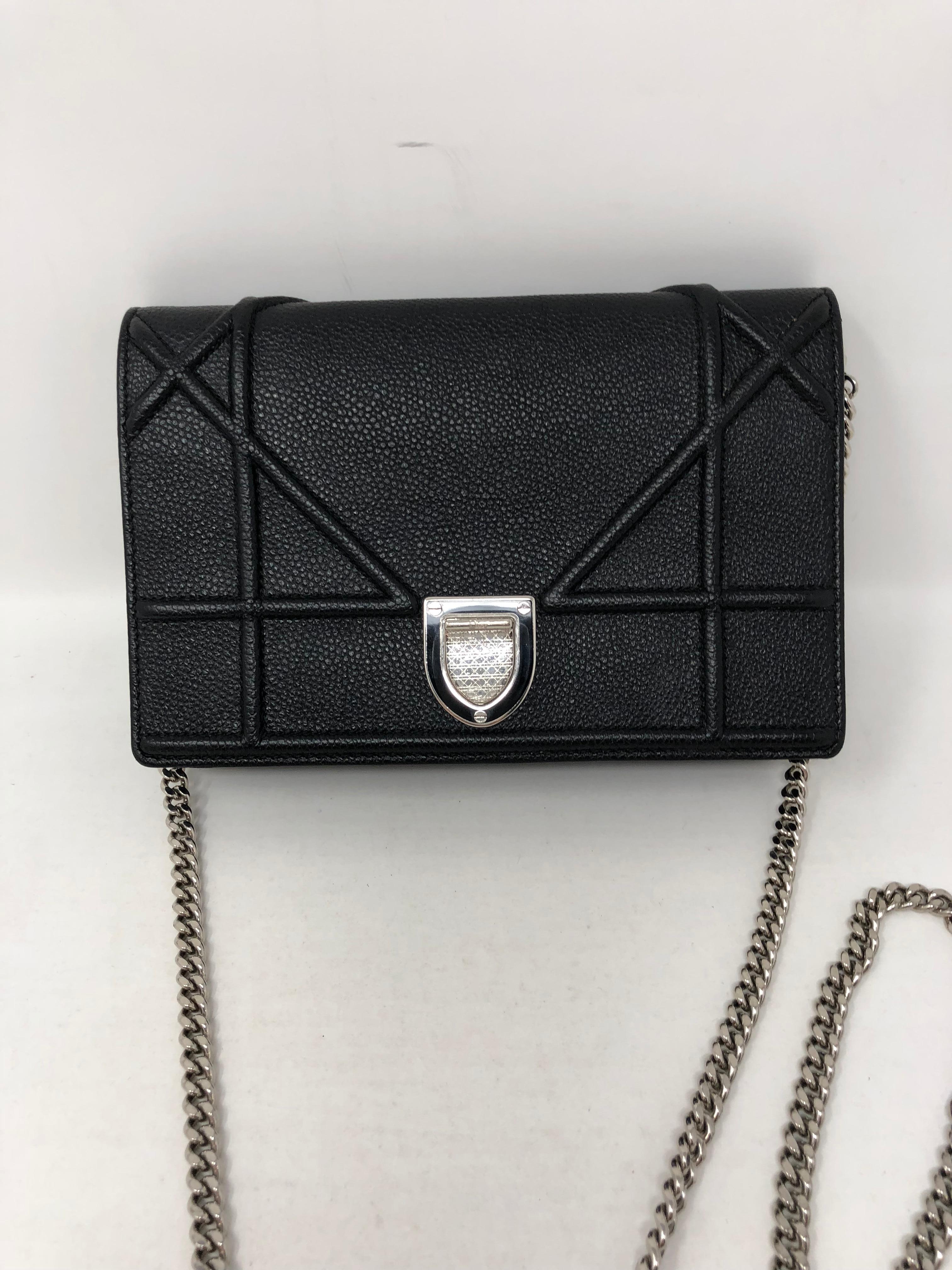 Christian Dior Diorama Black Mini Crossbody. Made of grained calfskin leather and in black. This wallet on a chain is the perfect accessory for day or night. Silver chain link crossbody or can be worn as a clutch.
