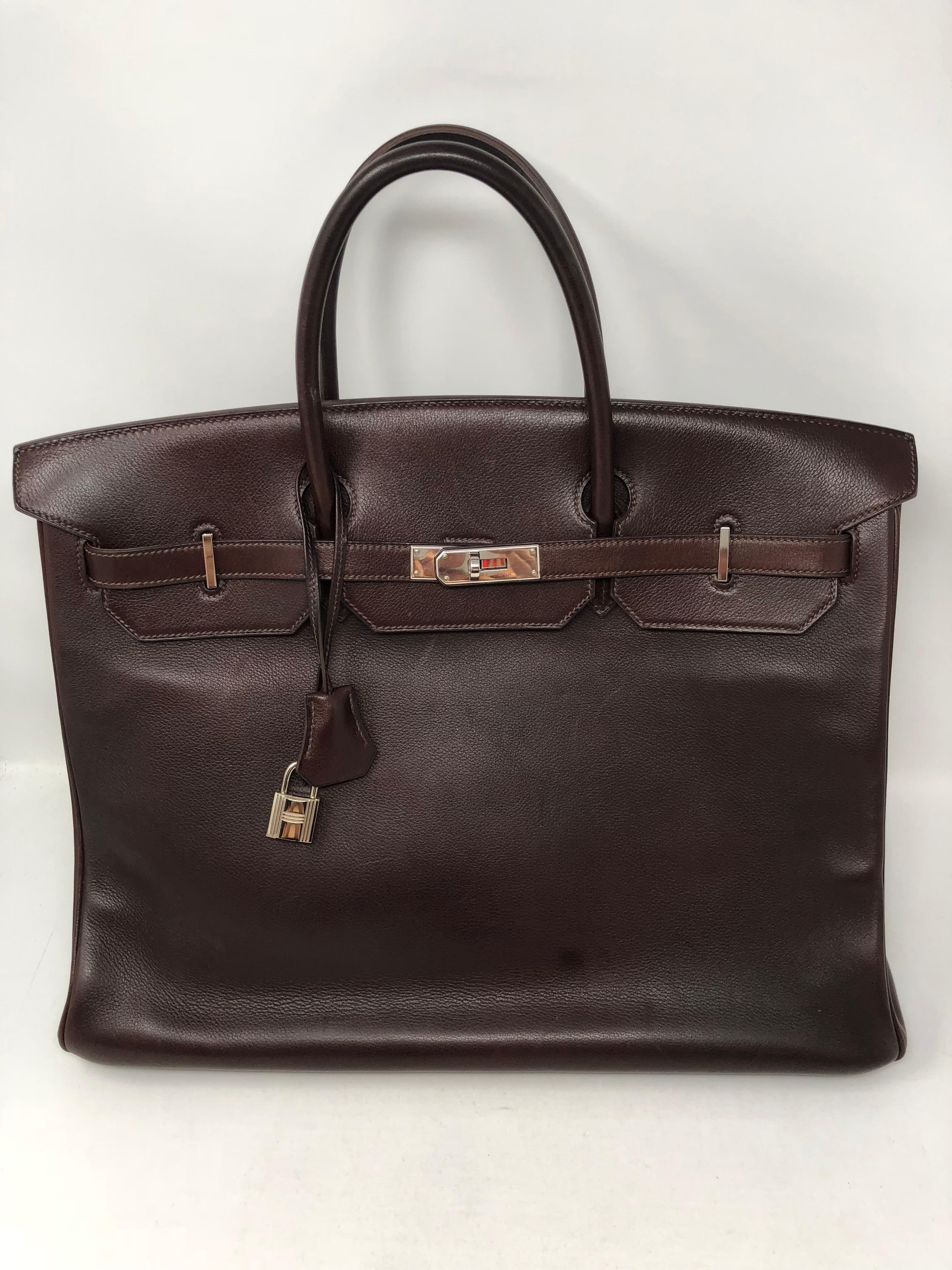 Hermes Birkin 40 Rouge in Swift leather. From 2009 and in good condition. Color is a very dark burgundy almost brown color. Palladium hardware. Neutral color and great travel size bag. Includes dustbag, key, lock and clochette. Guaranteed authentic. 