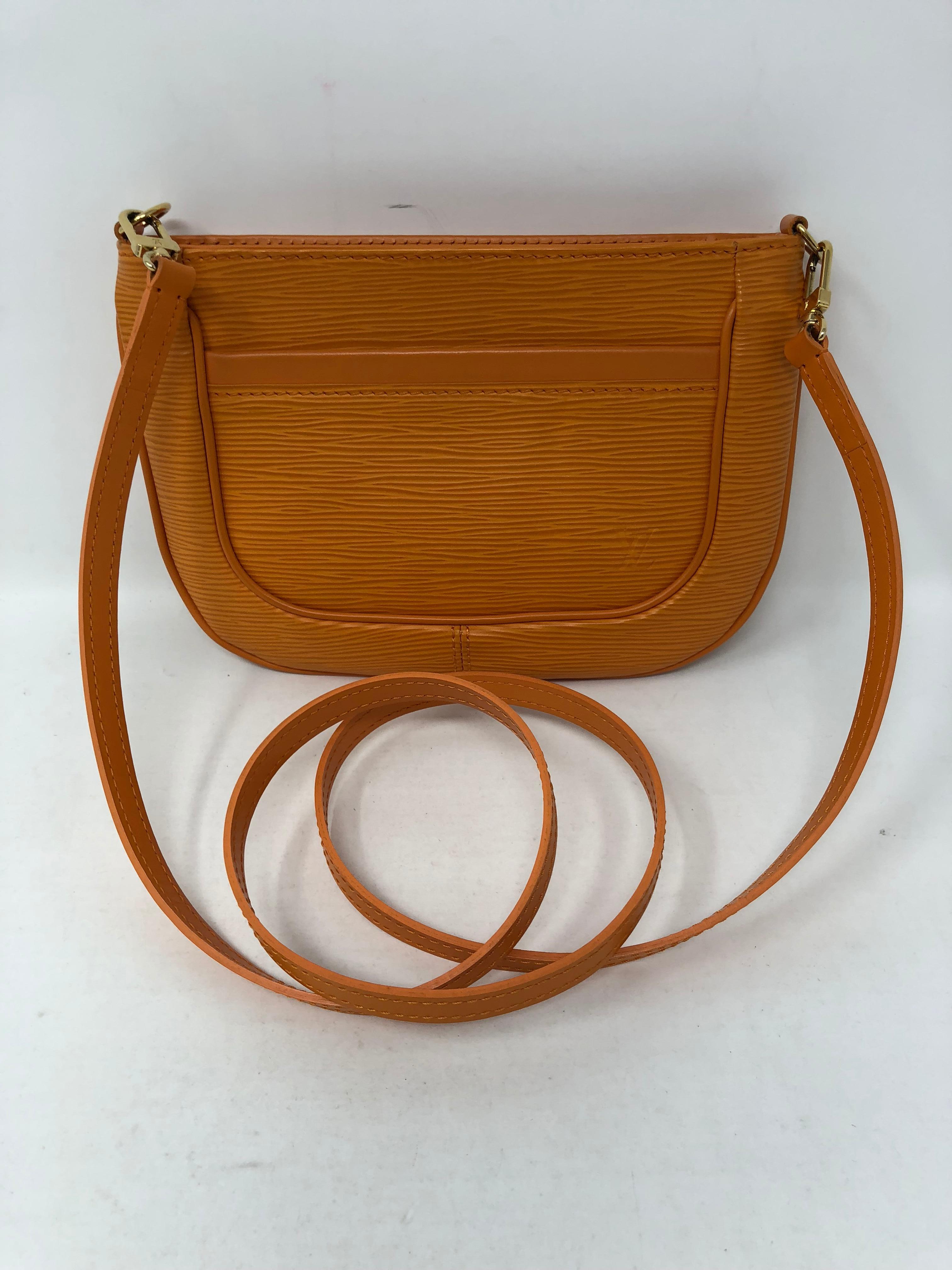 Louis Vuitton Orange Epi Leather crossbody bag. Made of durable epi leather in a mandarin orange color. Strap comes off and can be worn as a clutch. Like new condition. Guaranteed authentic. 