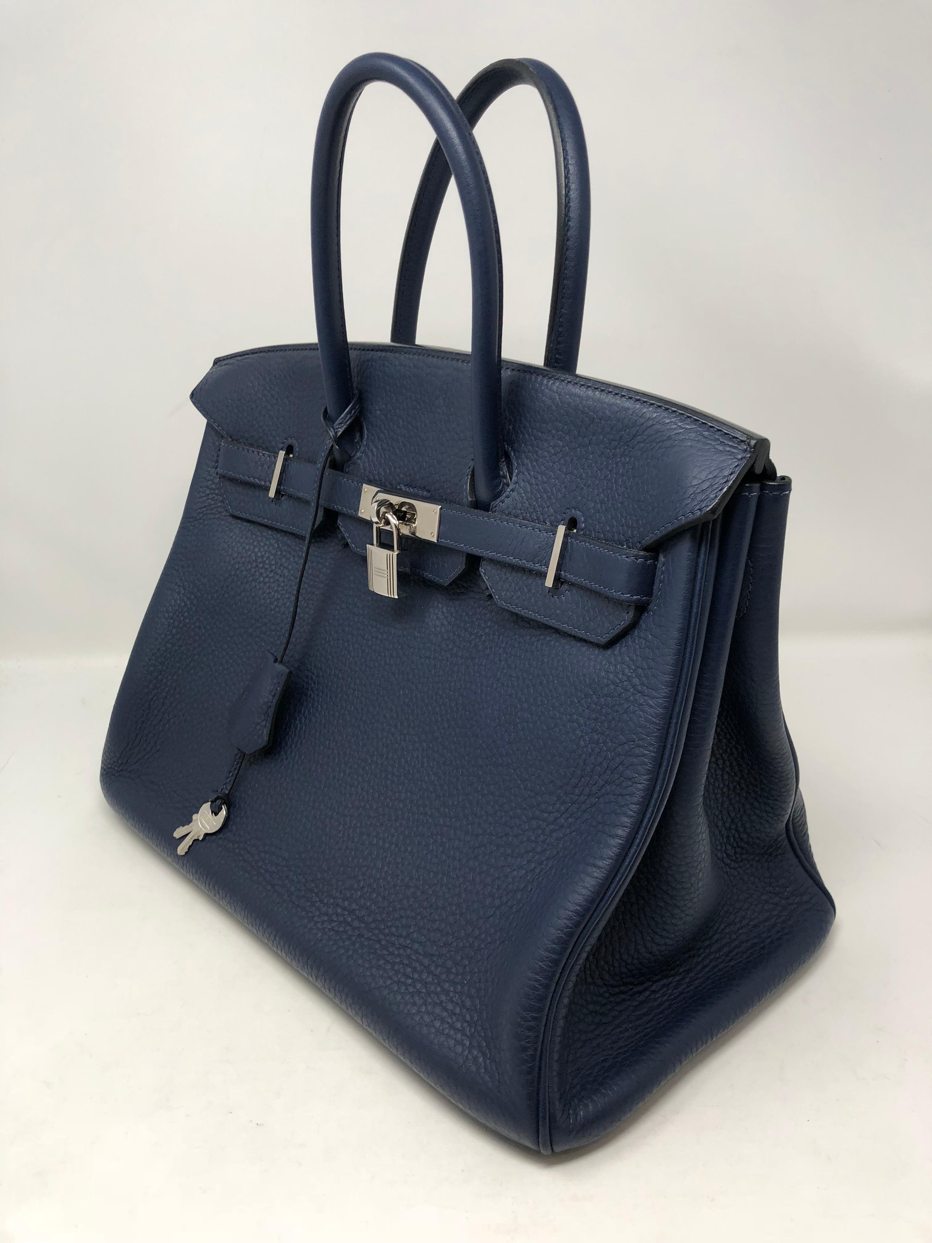 Hermes Birkin 35 Bleu Abysse with palladium hardware. This beautiful sapphire/ navy blue is more stunning in person. Mint condition with plastic still on front hardware. The Birkin is Clemence leather which holds up very well. Highly coveted color