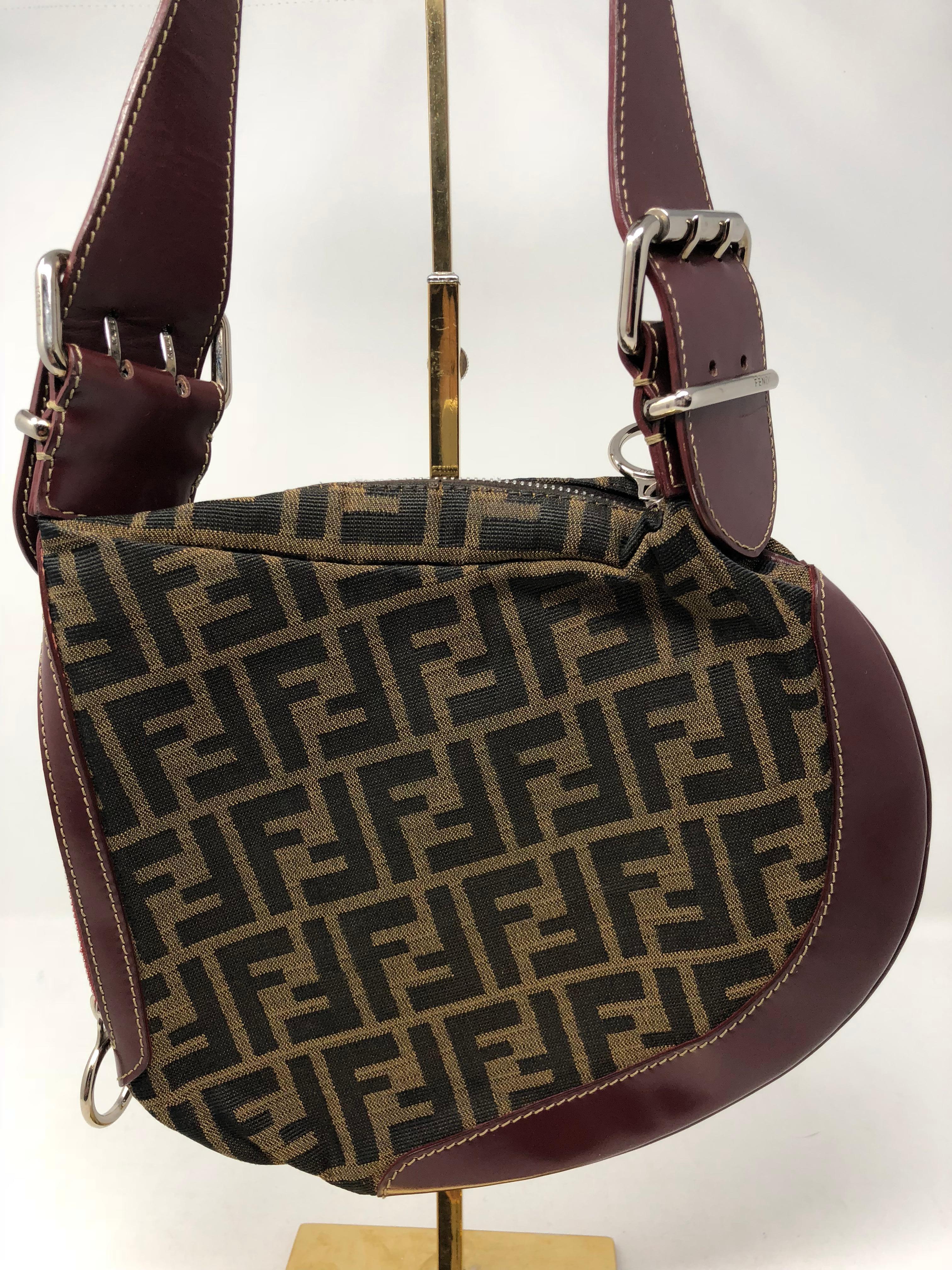 Fendi Monogram Saddle Bag with leather trim. Burgundy Leather handle and trim around the bag. Fendi Zucca print. Vintage Fendi bag in good condition. Fendi is back and so is this style. Guaranteed authentic. 