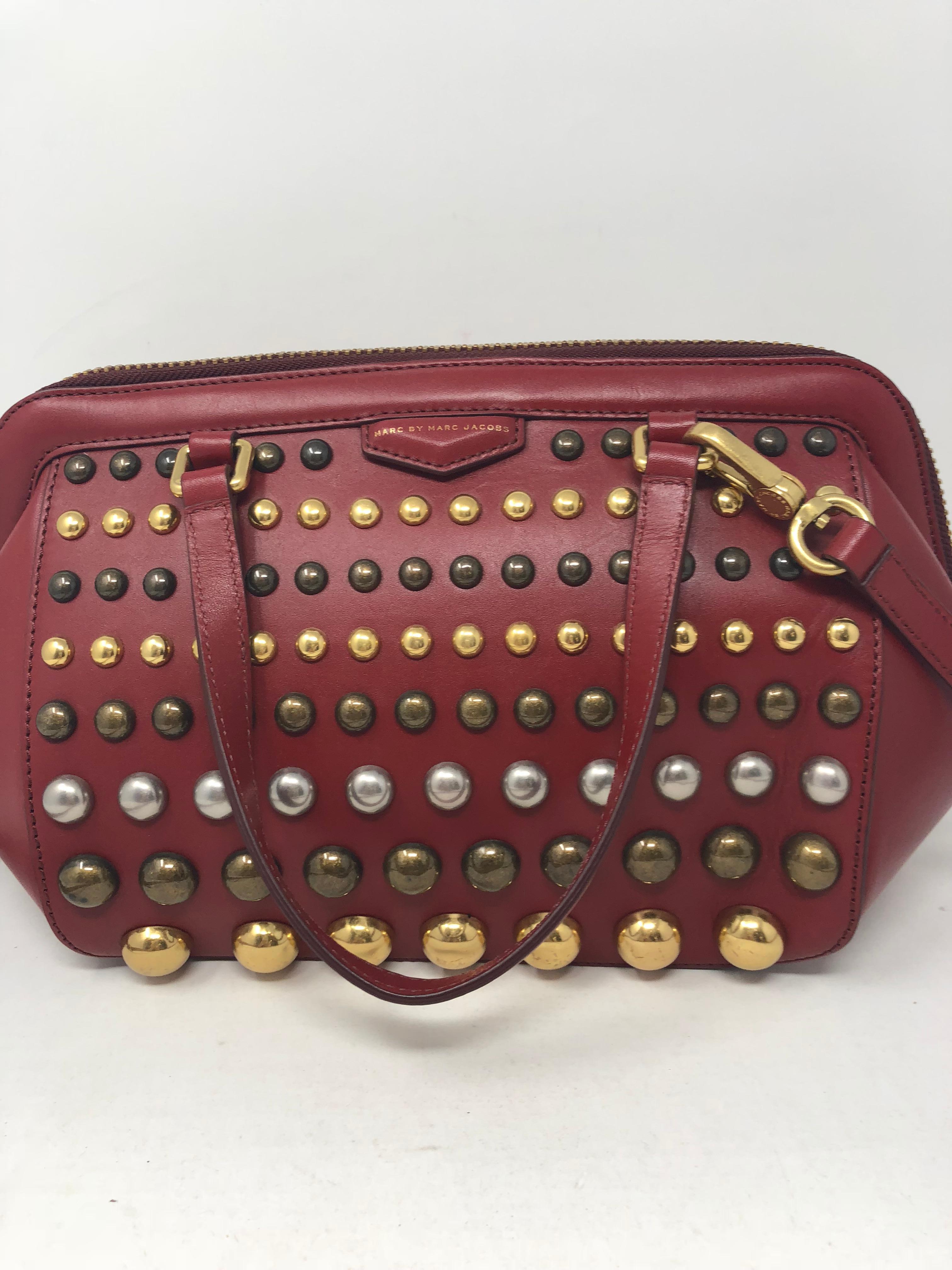 Marc Jacobs Red Studded Bag. Red leather bag with multi metal studs throughout. Never worn with original tags. Unique style with adjustable leather strap. Guaranteed authentic. 